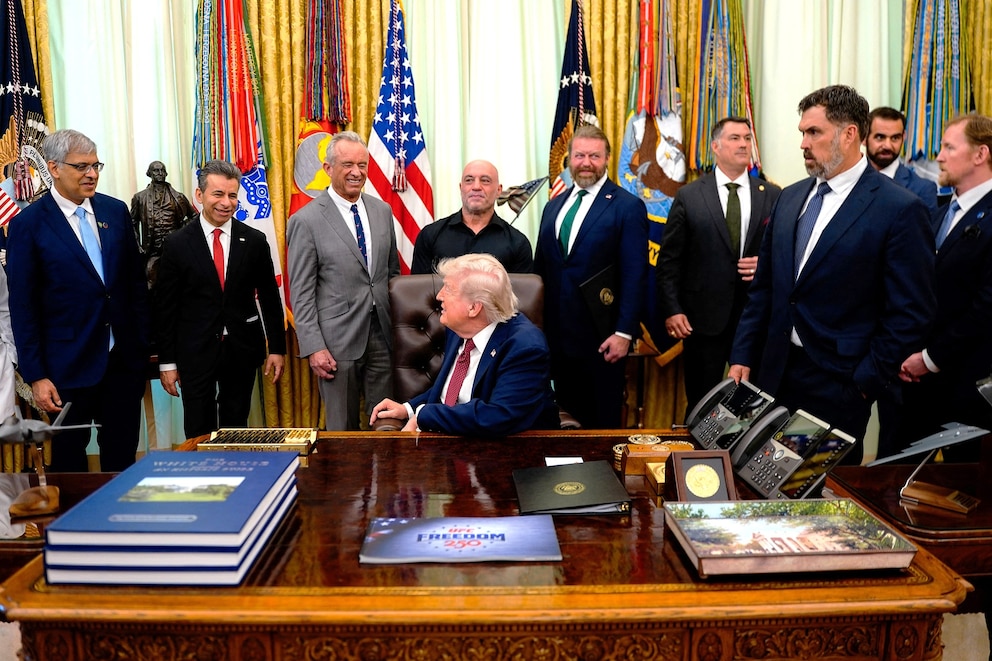 PHOTO: U.S. President Trump signs executive order about easing restrictions on mental health treatments, at the White House