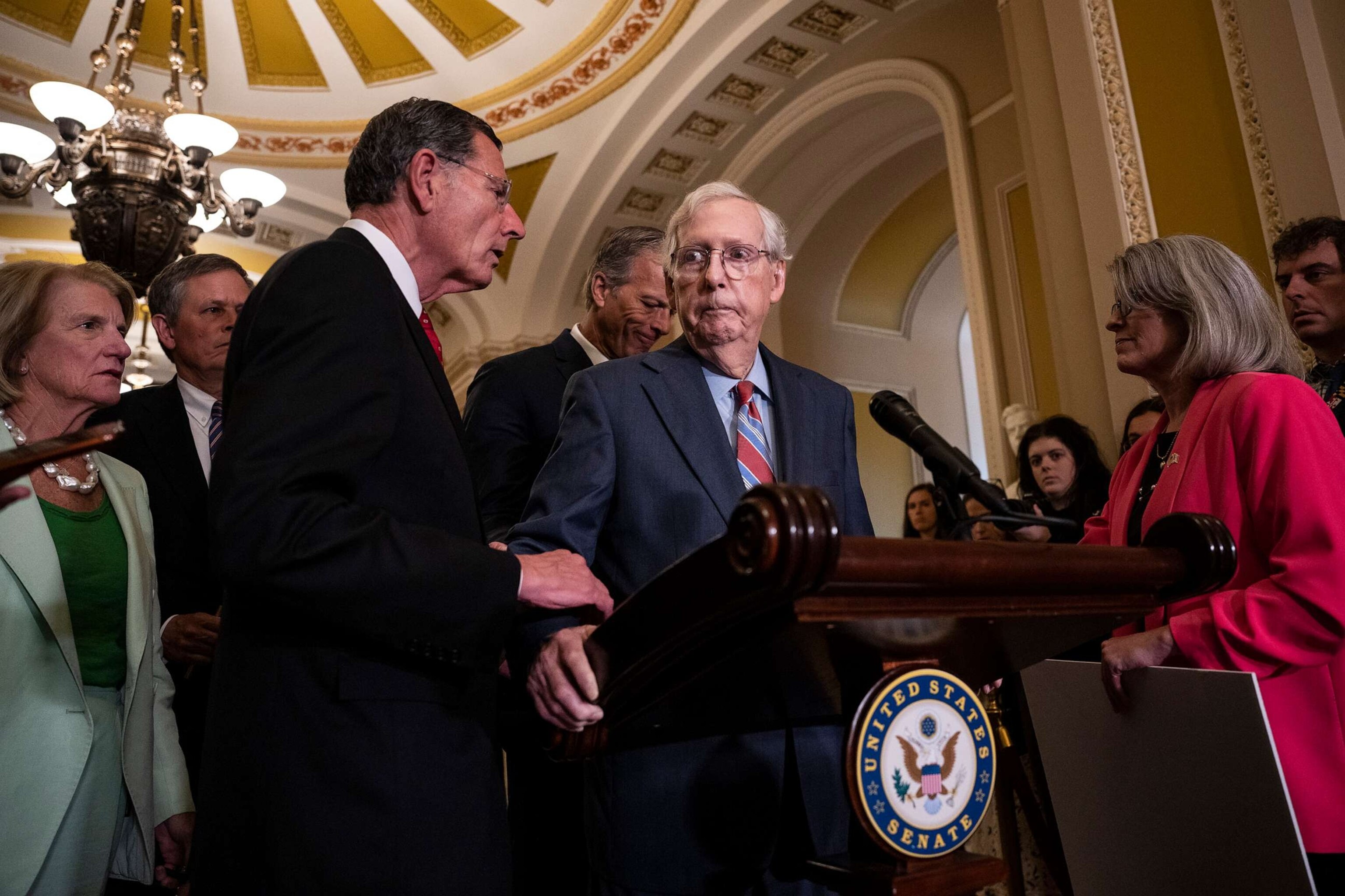 PHOTO: Sen. John Barrasso reaches out to help Senate Minority Leader Mitch McConnell after McConnell froze and stopped talking at the microphones during a news conference on July 26, 2023 in Washington, D.C.