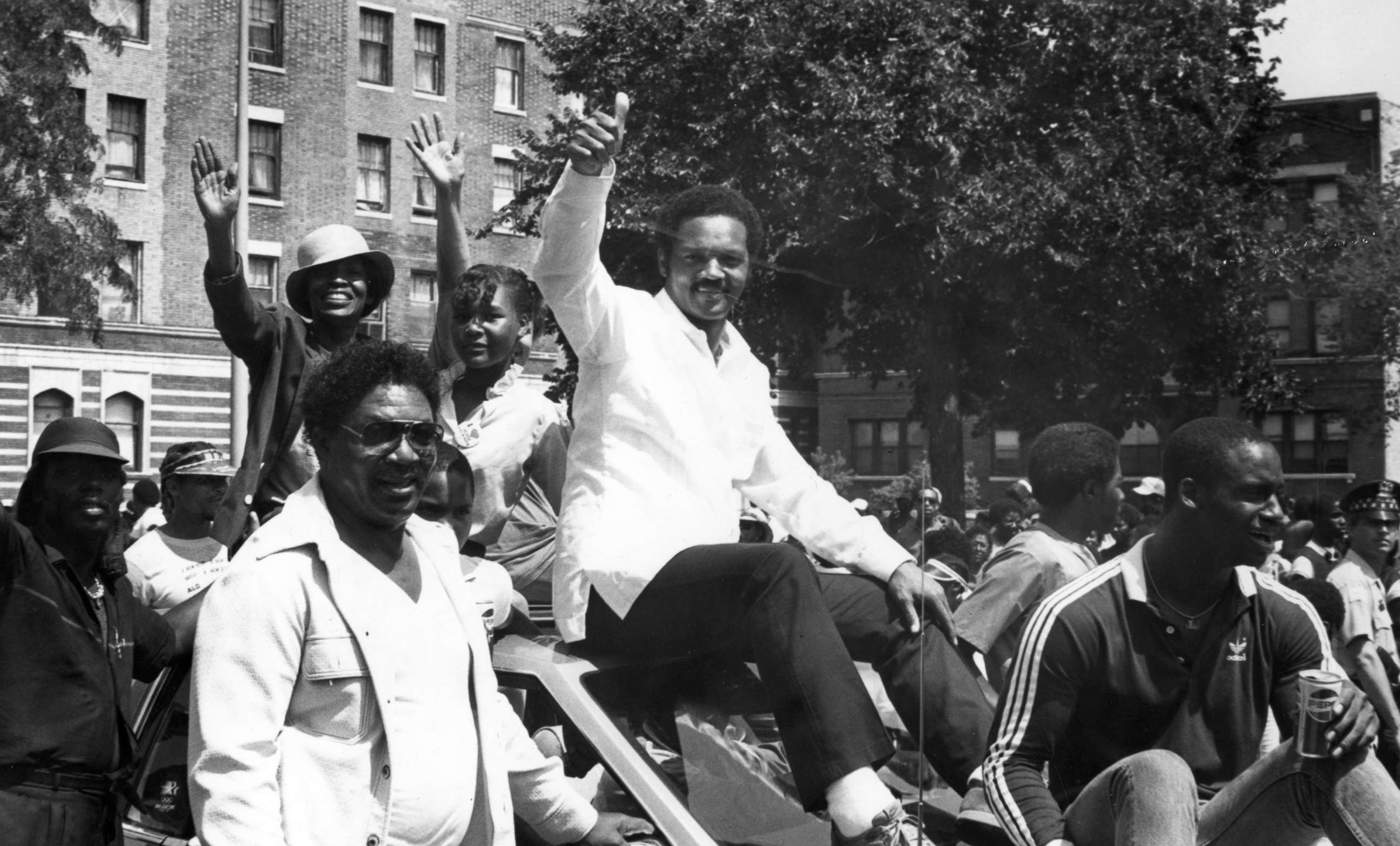 PHOTO: Civil Rights leader and politician Jesse Jackson gives a 'thumbs up' as he greets supporters from the roof of an car during the Bud Billiken parade, sponsored by the Chicago Defender, in Chicago, in 1985.