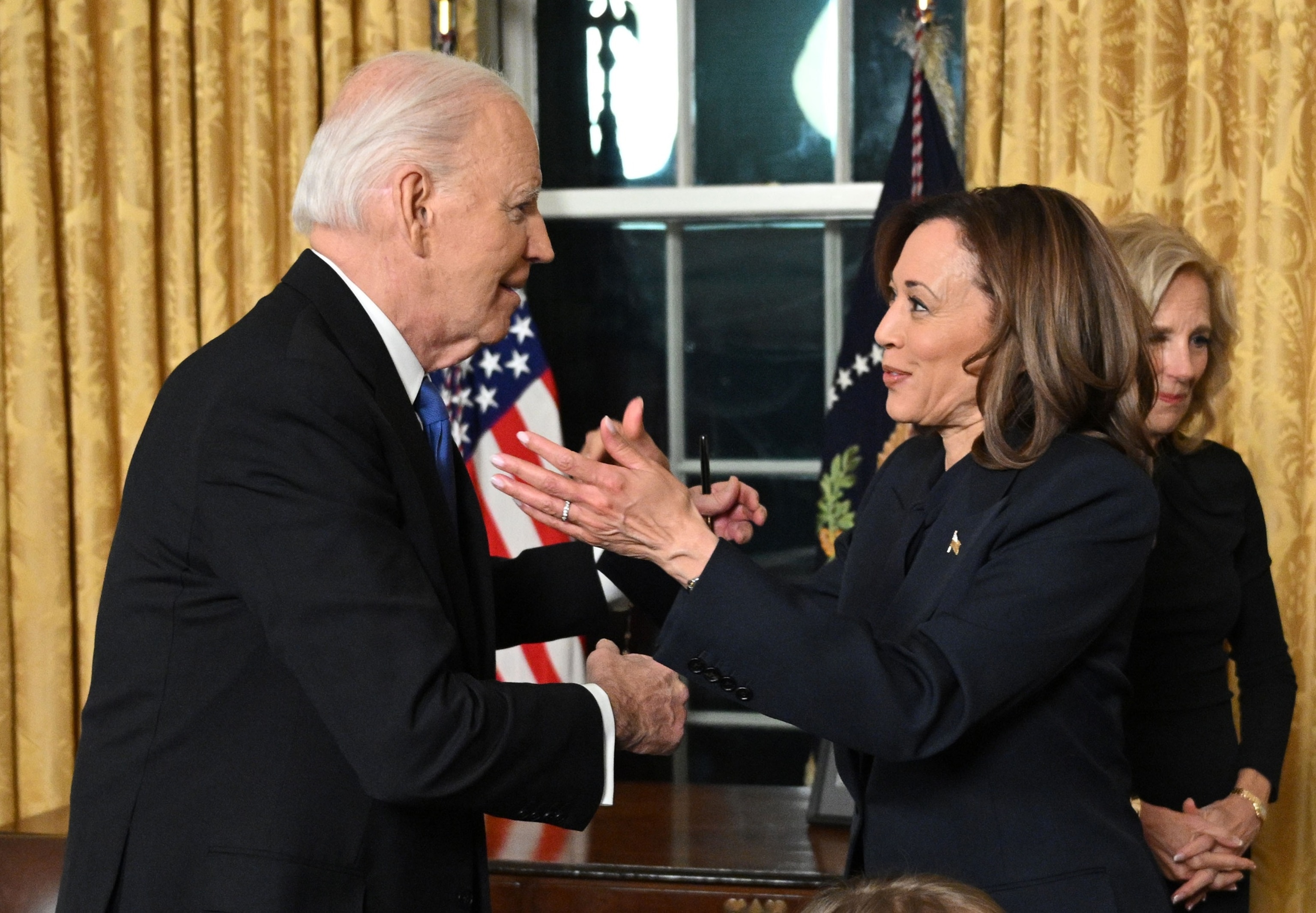 PHOTO: President Joe Biden and Vice-President Kamala Harris go for a hug after the President delivered his farewell address to the nation from the Oval Office of the White House on January 15, 2025 in Washington, DC.