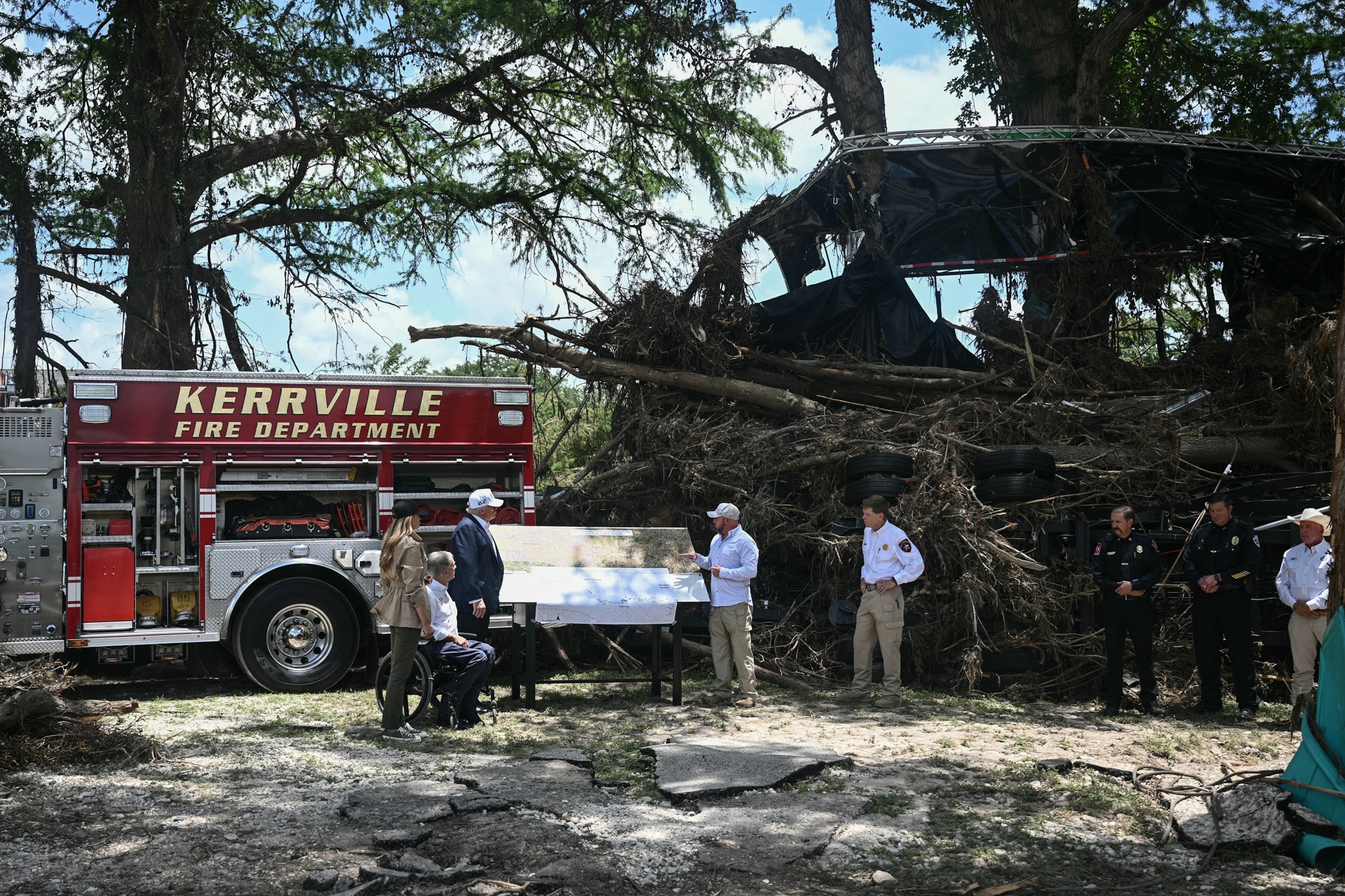 PHOTO: Donald Trump, Texas Governor Greg Abbott and Melania Trump meet with local officials and first reponders following devastating flooding that ocurred in the area over the July 4 weekend, in Kerrville, Texas, on July 11, 2025.