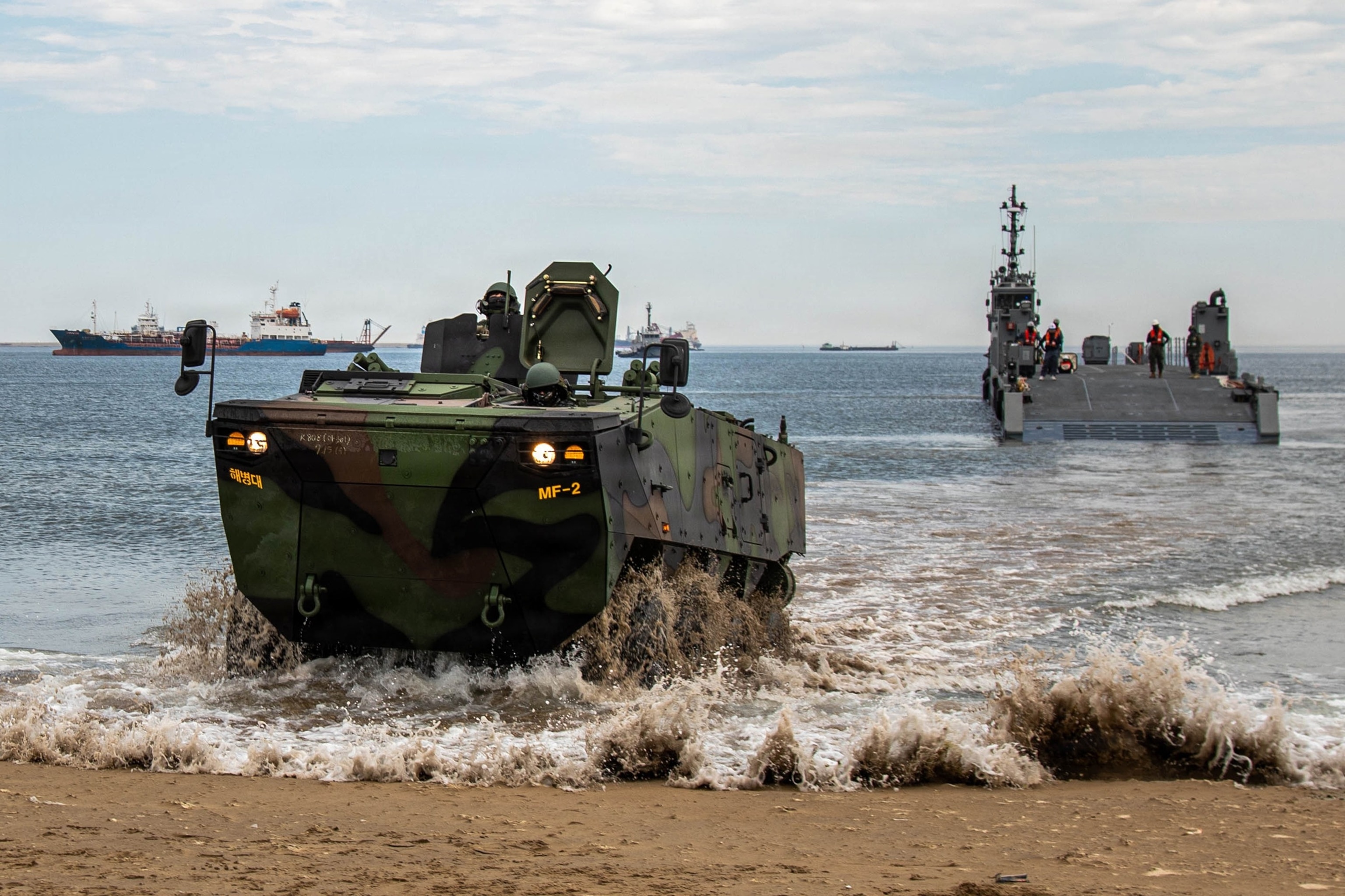PHOTO: A Republic of Korea Army soldier drives a K808 wheeled armored vehicle onto the shore during an amphibious offloading demonstration as part of the Combined Joint Logistics Over-the-Shore 2026 exercise at Pohang Port, South Korea, July 16, 2026. 