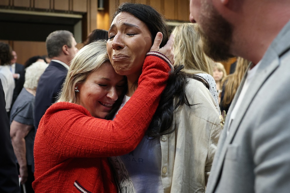 PHOTO: Epstein survivor Dani Bensky (L) embraces Amanda Roberts after Bensky finished testifying on Capitol Hill during the confirmation hearing for Todd Blanche as the Attorney General, July 16, 2026 in Washington.