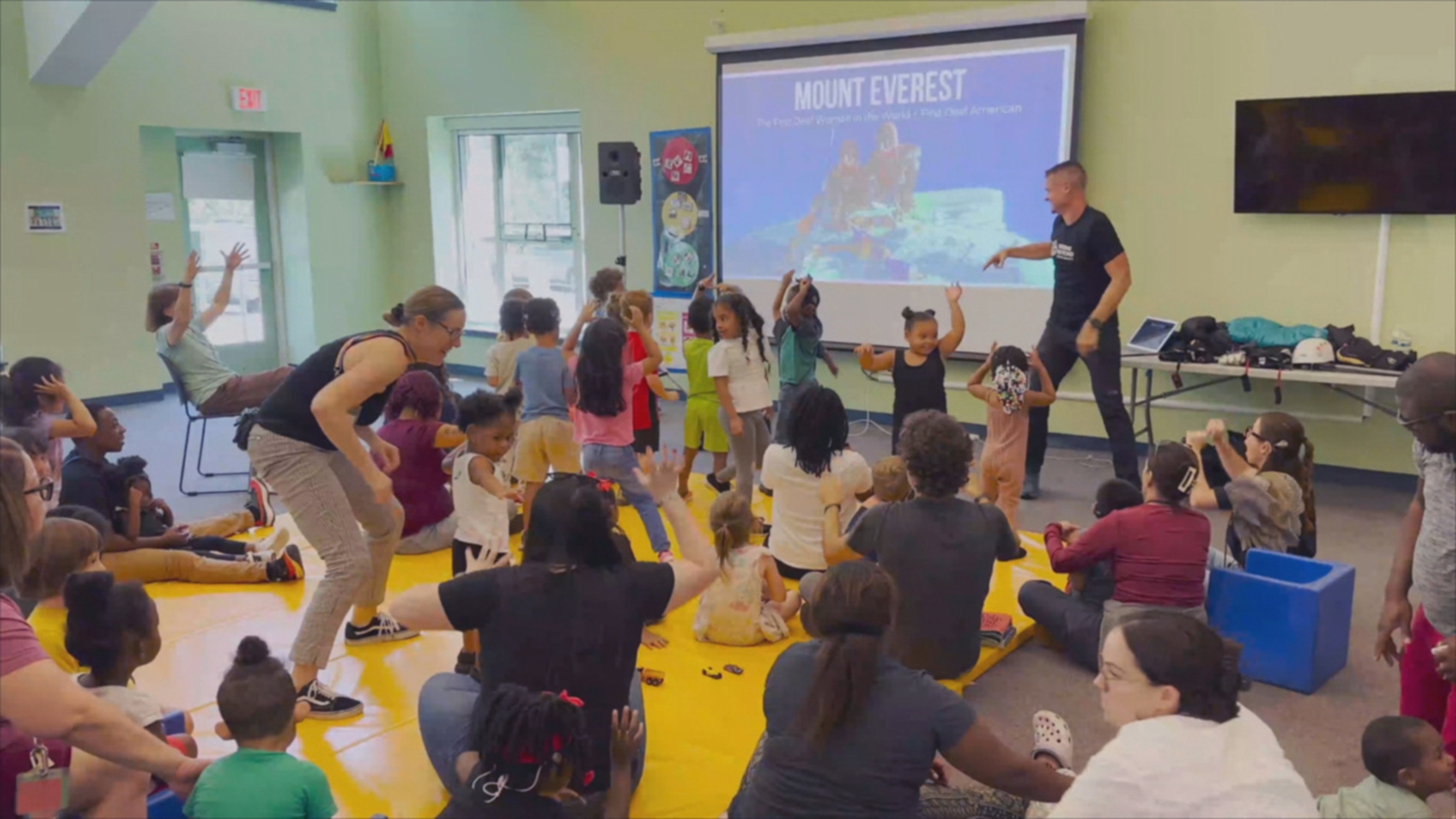 PHOTO: Shayna Unger and Scott Lehmann speak with deaf students.