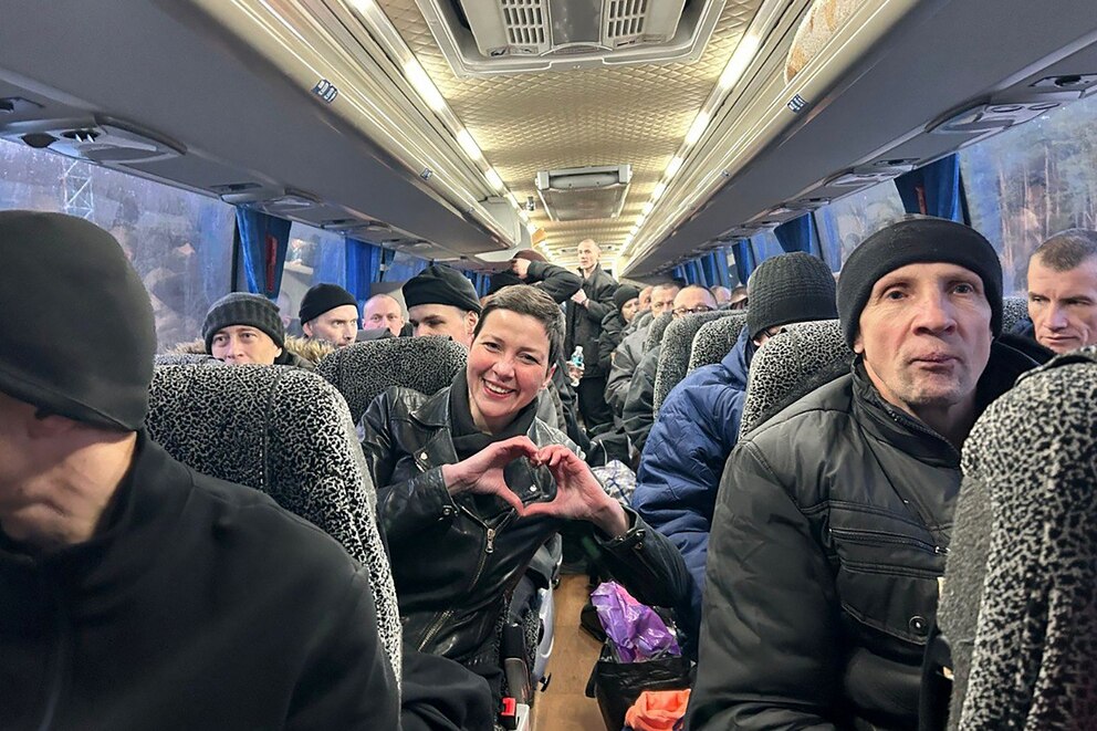 PHOTO: Maria Kalesnikava (C), a coordinator of Viktar Babaryka's campaign headquarters, making a heart sign with her hands as she sits in a bus among other former prisoners at an undisclosed location in Ukraine, Dec. 13, 2025.