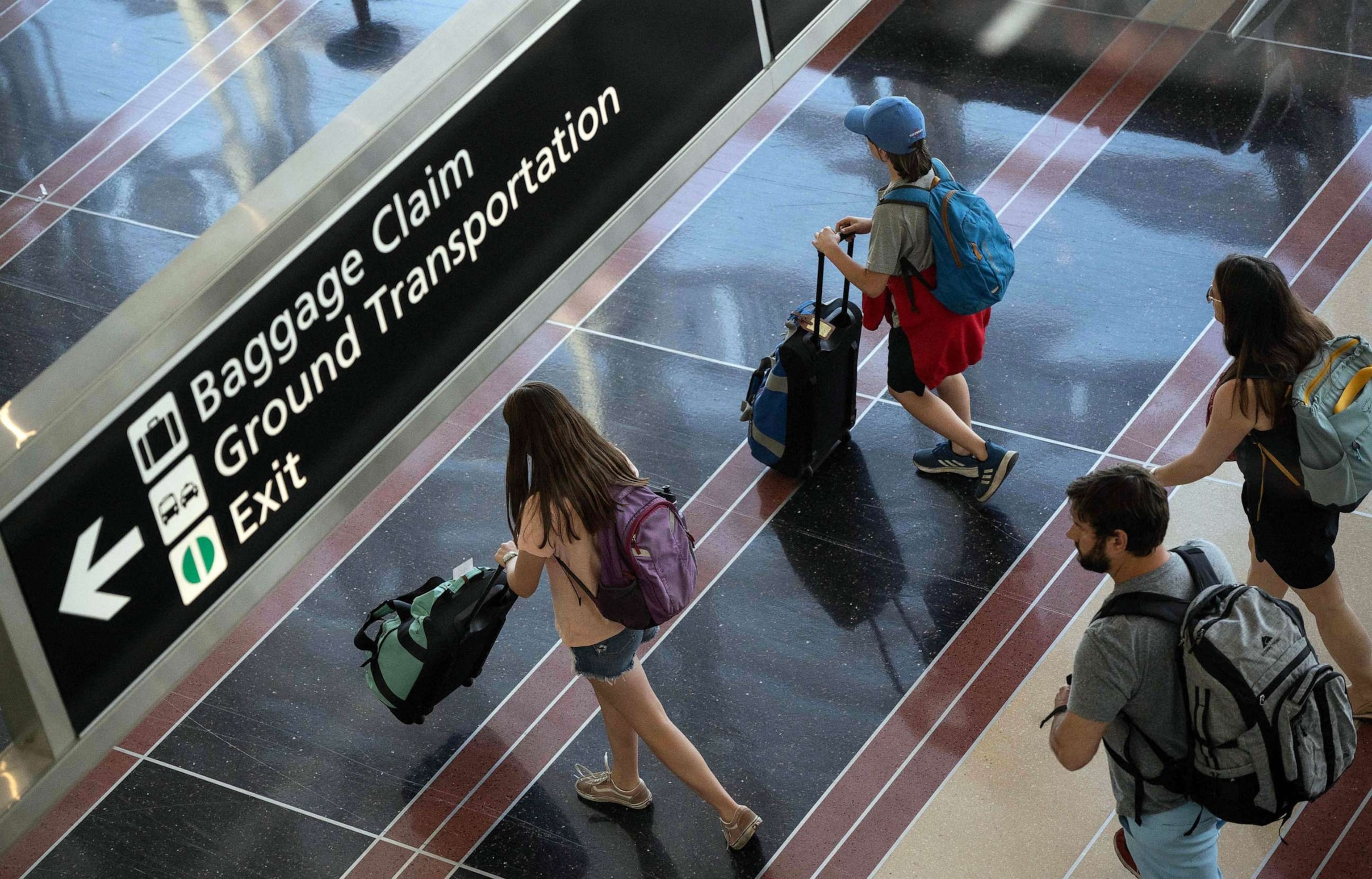 PHOTO: FILE - Passengers walk through Reagan National Airport in Arlington, Va., May 26, 2023.