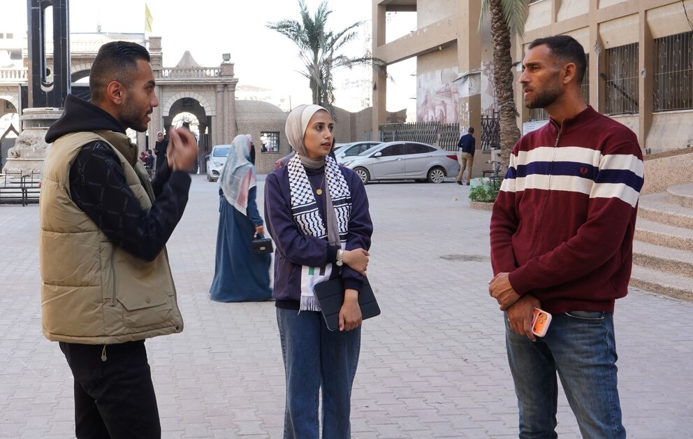 PHOTO: Mira Al-Agha, a first-year student at the Faculty of Dentistry at Al-Azhar University in Gaza, stands with her colleagues in higher levels and inquires about their study methods.
