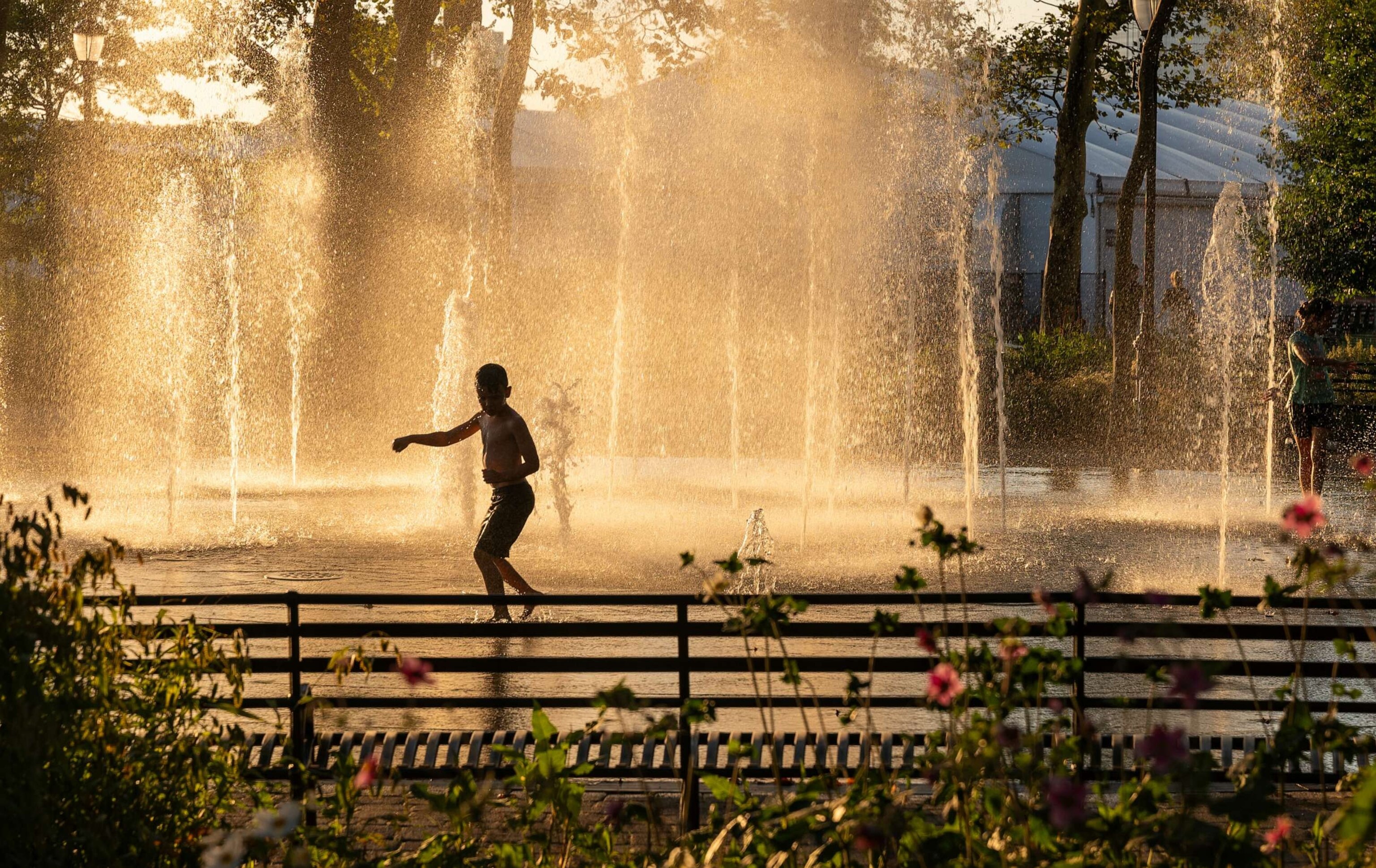 PHOTO: In this Sept. 6, 2023, file photo, a child runs through cool a fountain in Battery Park New York.