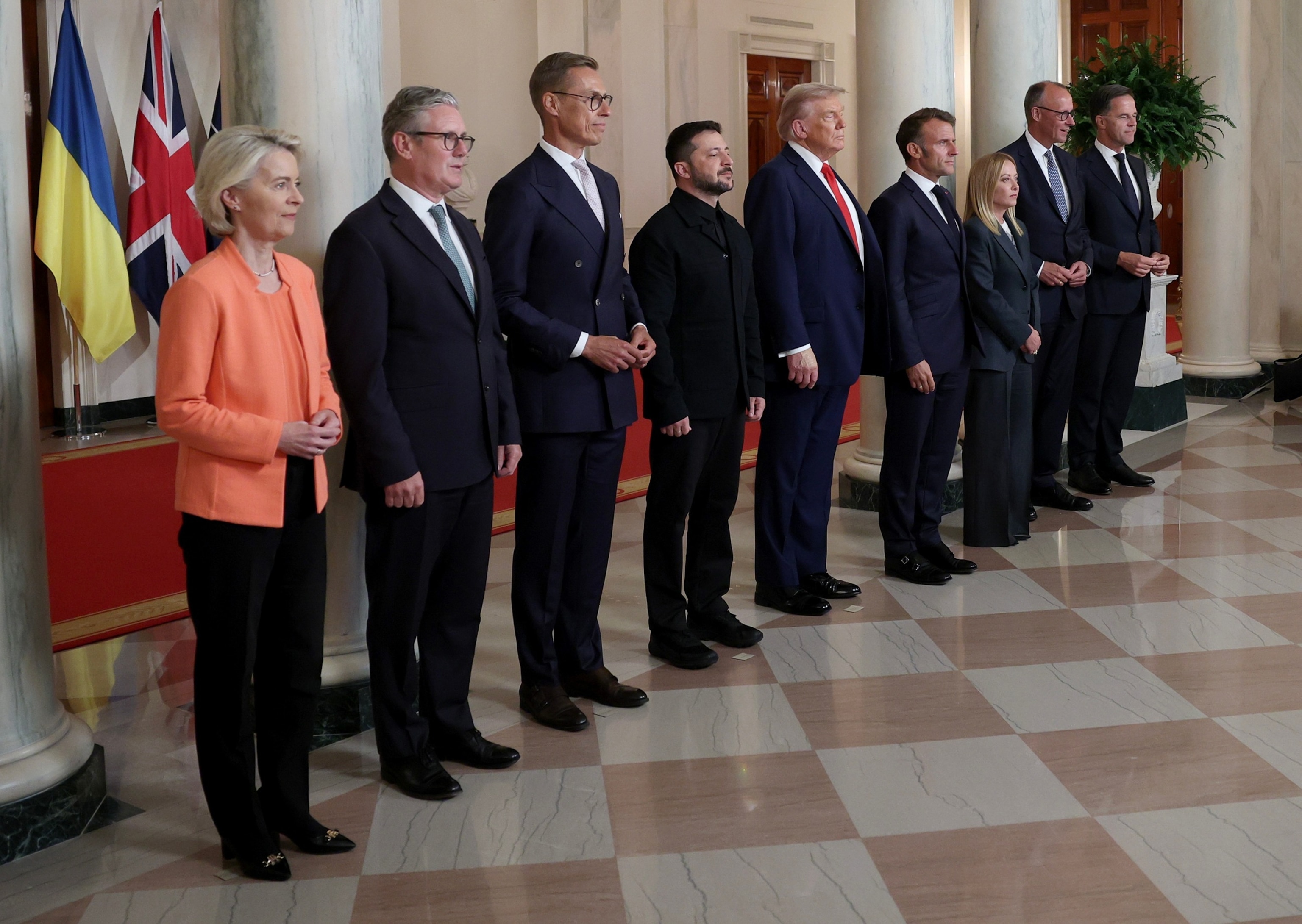 PHOTO: Ukrainian President Volodymyr Zelensky and President Donald Trump pose for a family photo with European leaders in the Cross Hall of the White House in Washington, August 18, 2025.