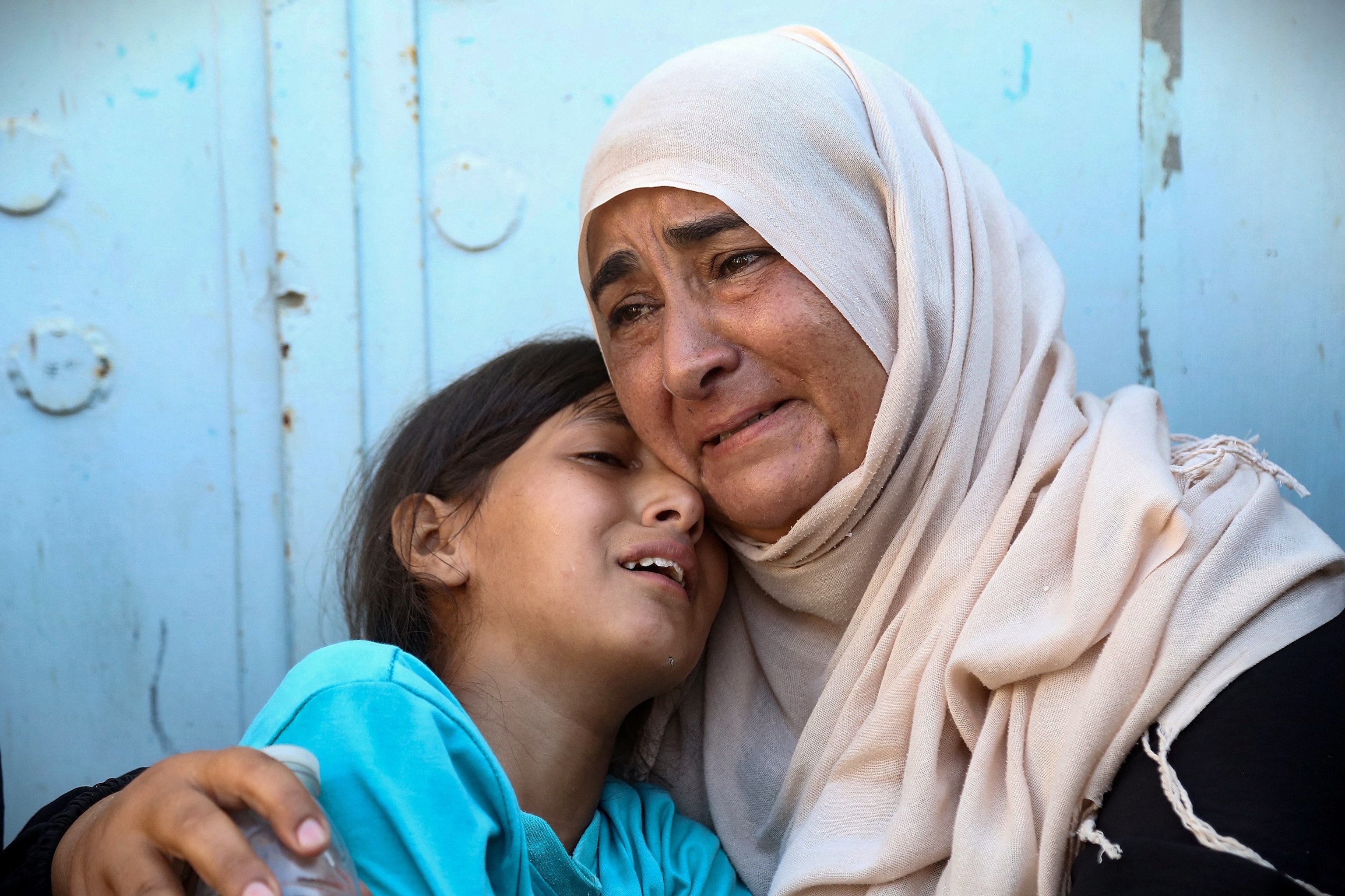 PHOTO: A woman and child react after identifying the body of a family member at Nasser hospital, among Palestinians killed in Israeli strikes on the al-Mawasi refugee camp and the eastern neighborhoods of Khan Yunis in the Gaza Strip, on July 24, 2025.