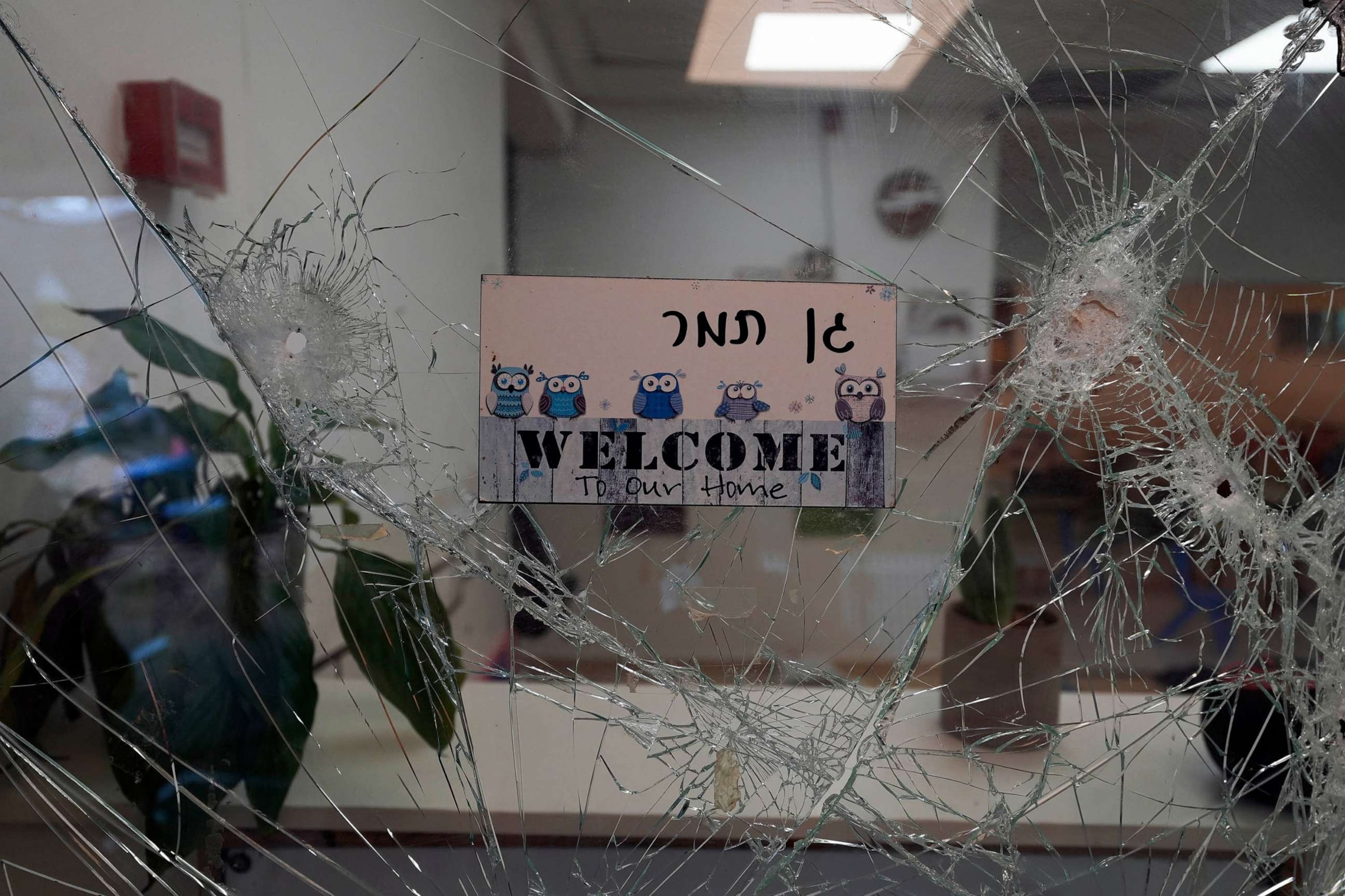 PHOTO:A bullet-shuttered window of the entrance to a kindergarten is seen in Kibbutz Be'eri, Oct. 11, 2023.