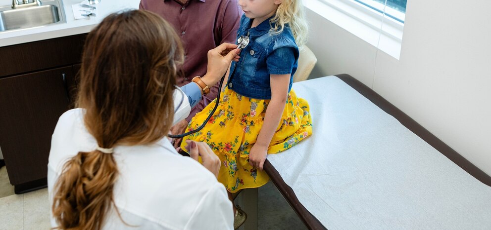 PHOTO: A doctor checks a child at an office in an undated stock photo. 