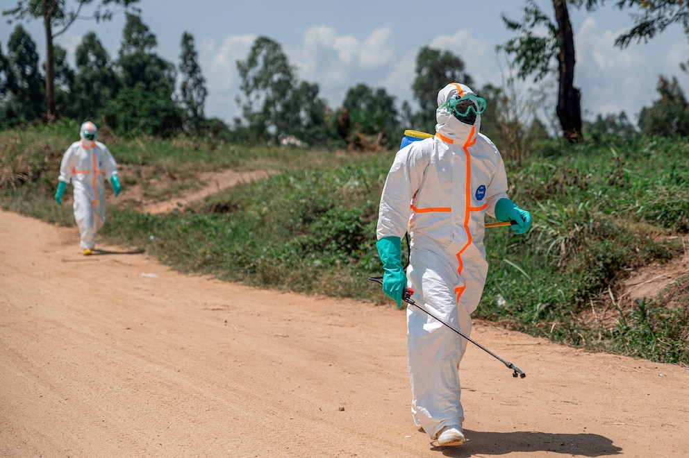 PHOTO: Health workers, wearing protective gear, retrieve the body of a citizen who died of Ebola virus from the Rwampara Hospital morgue for burial procedures, in the Democratic Republic of the Congo, on June 8, 2026.