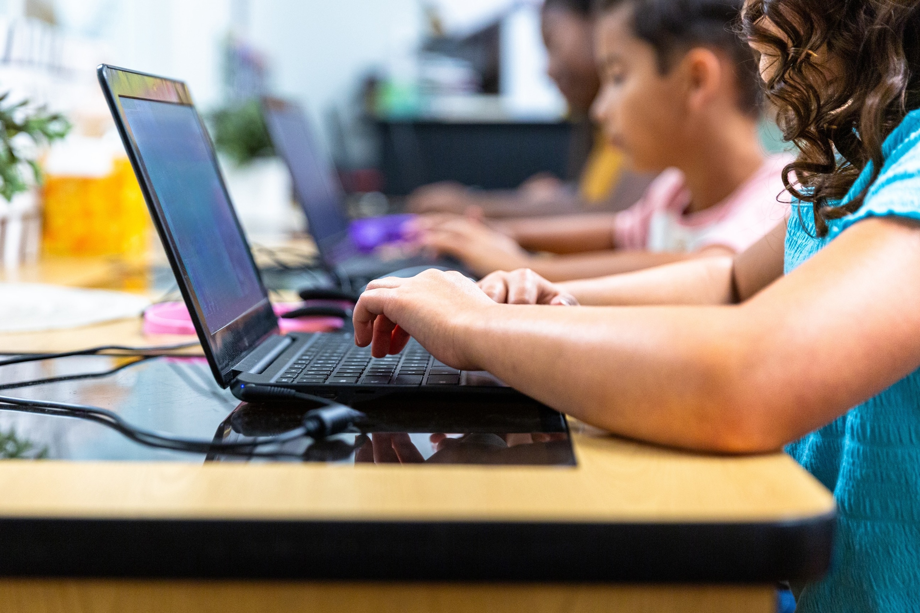 PHOTO: Elementary Students learning in the computer lab with their teacher