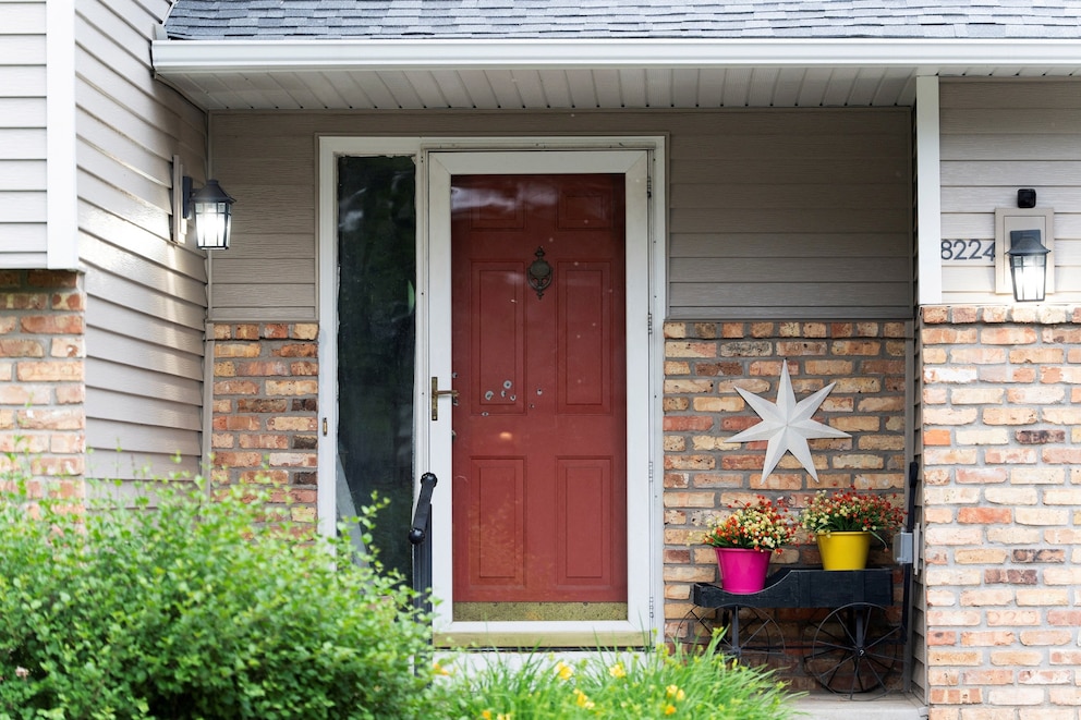 PHOTO: Bullet holes mark the front door of Minnesota state  Senator John Hoffman, who was shot alongside his wife, Yvette, in Champlin, Minn., June 14, 2025. 
