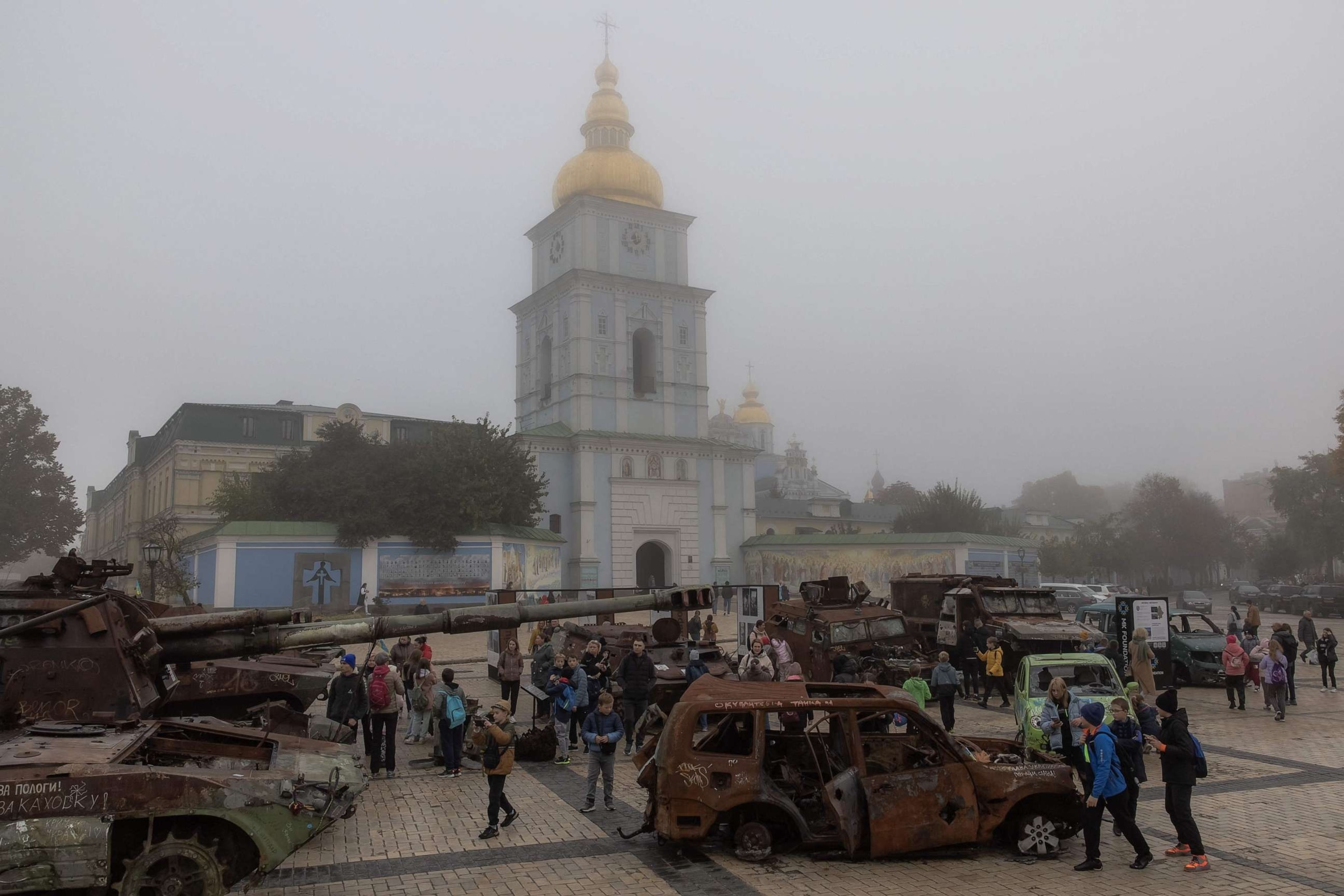 PHOTO: People look at destroyed Russian military vehicles on display in front of Saint Michael's Golden-Domed Monastery on a foggy day, in Kyiv, on Oct. 22, 2023, amid the Russian invasion of Ukraine.