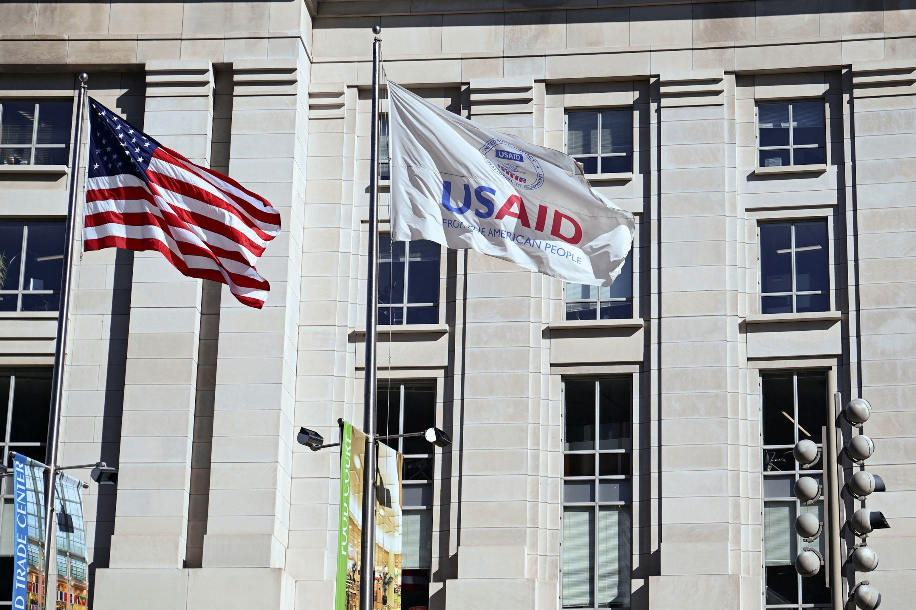 PHOTO: An American flag and USAID flag fly outside the USAID building in Washington, D.C., Feb. 1, 2025.