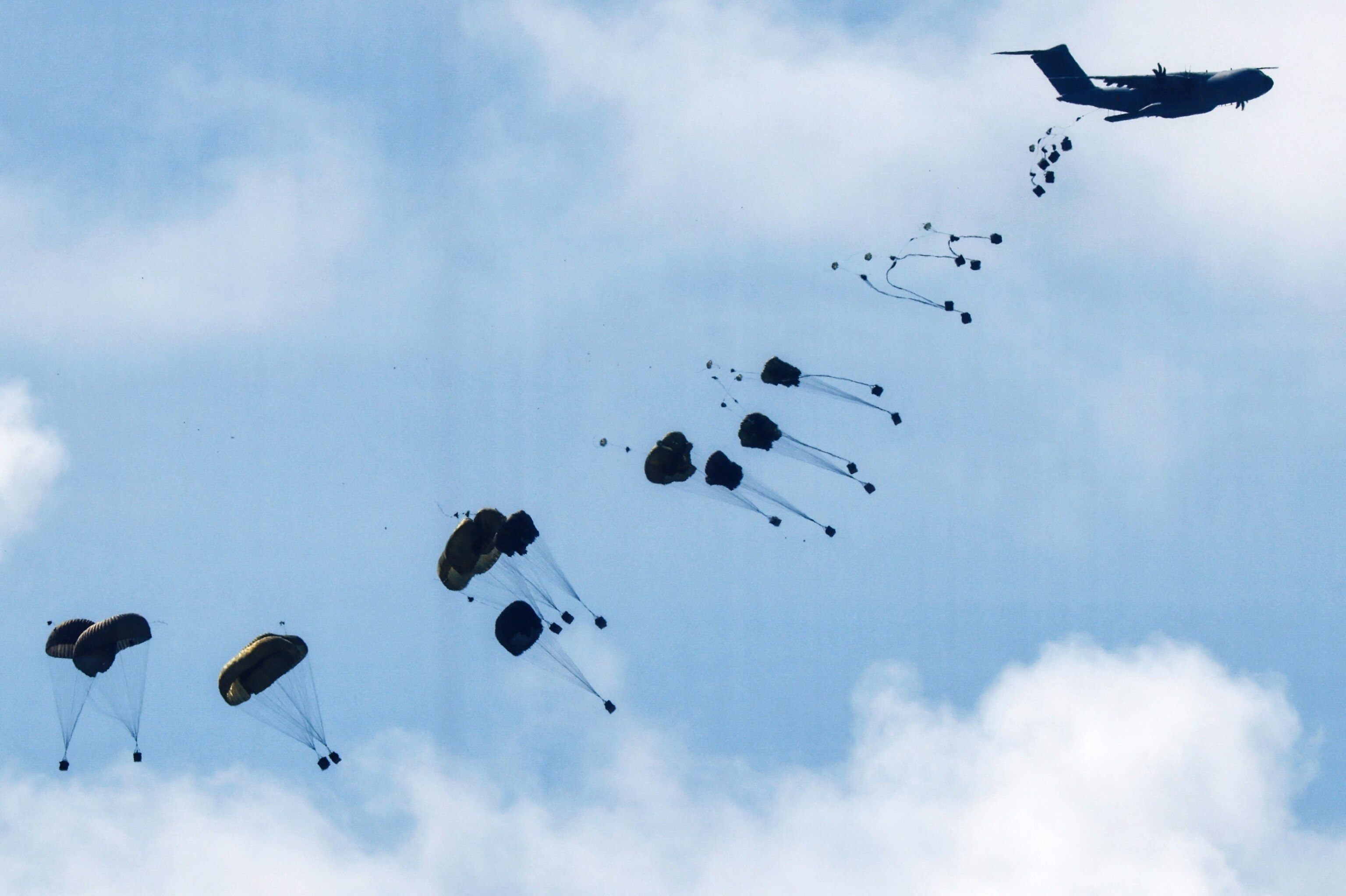 PHOTO: A military aircraft drops packages towards Gaza, amid the ongoing conflict between Israel and the Palestinian group Hamas, as seen from the border with Gaza in southern Israel March 7, 2024.