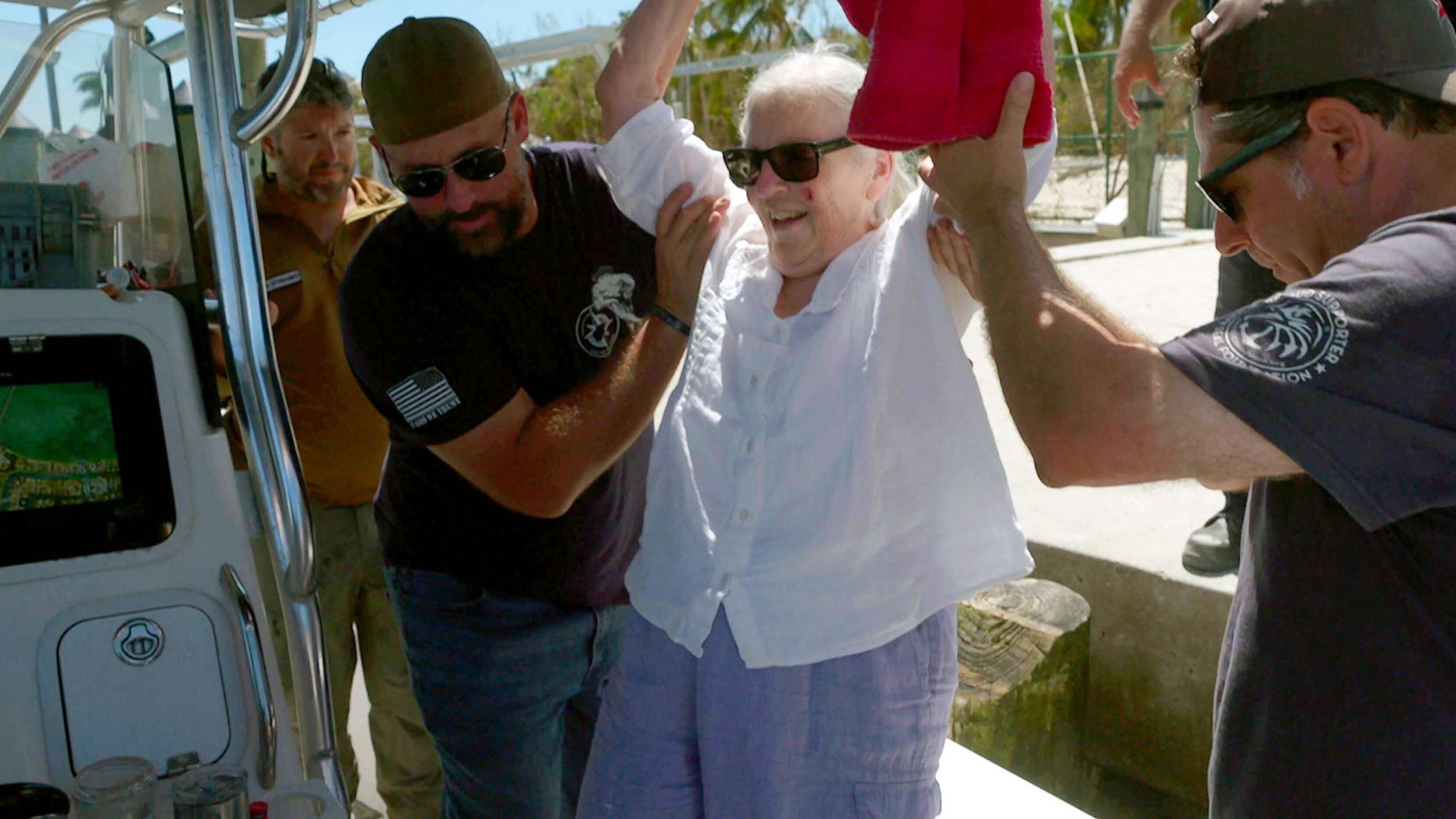 PHOTO: Betty Reynolds is assisted as she boards a rescue boat after Hurricane Ian flooded her home on Sanibel Island, Fla., Oct. 1, 2022.