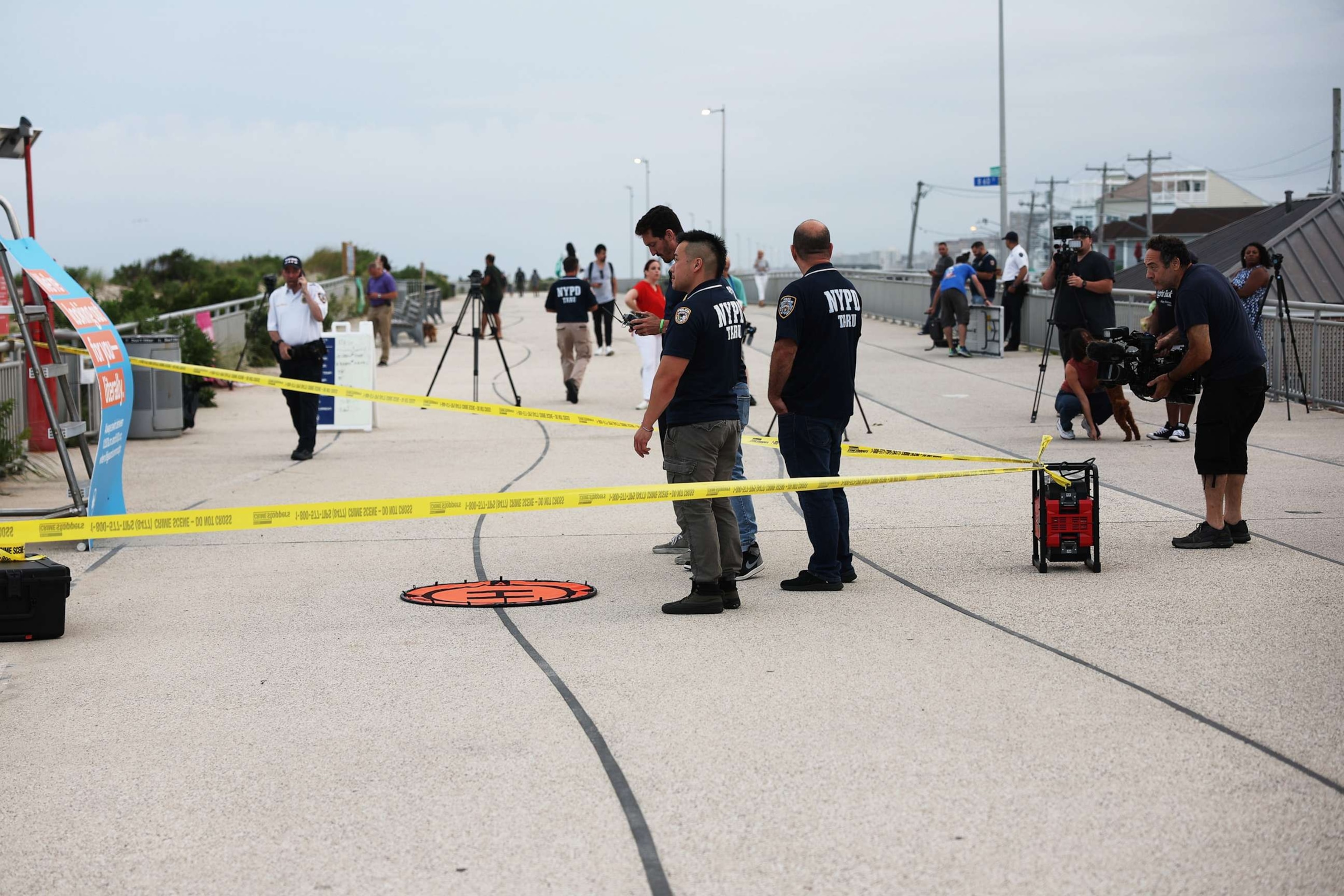 PHOTO: Police gather along Rockaway Beach at 59th Street after a woman was attacked by a shark in the early evening on Aug. 7, 2023 in New York City.