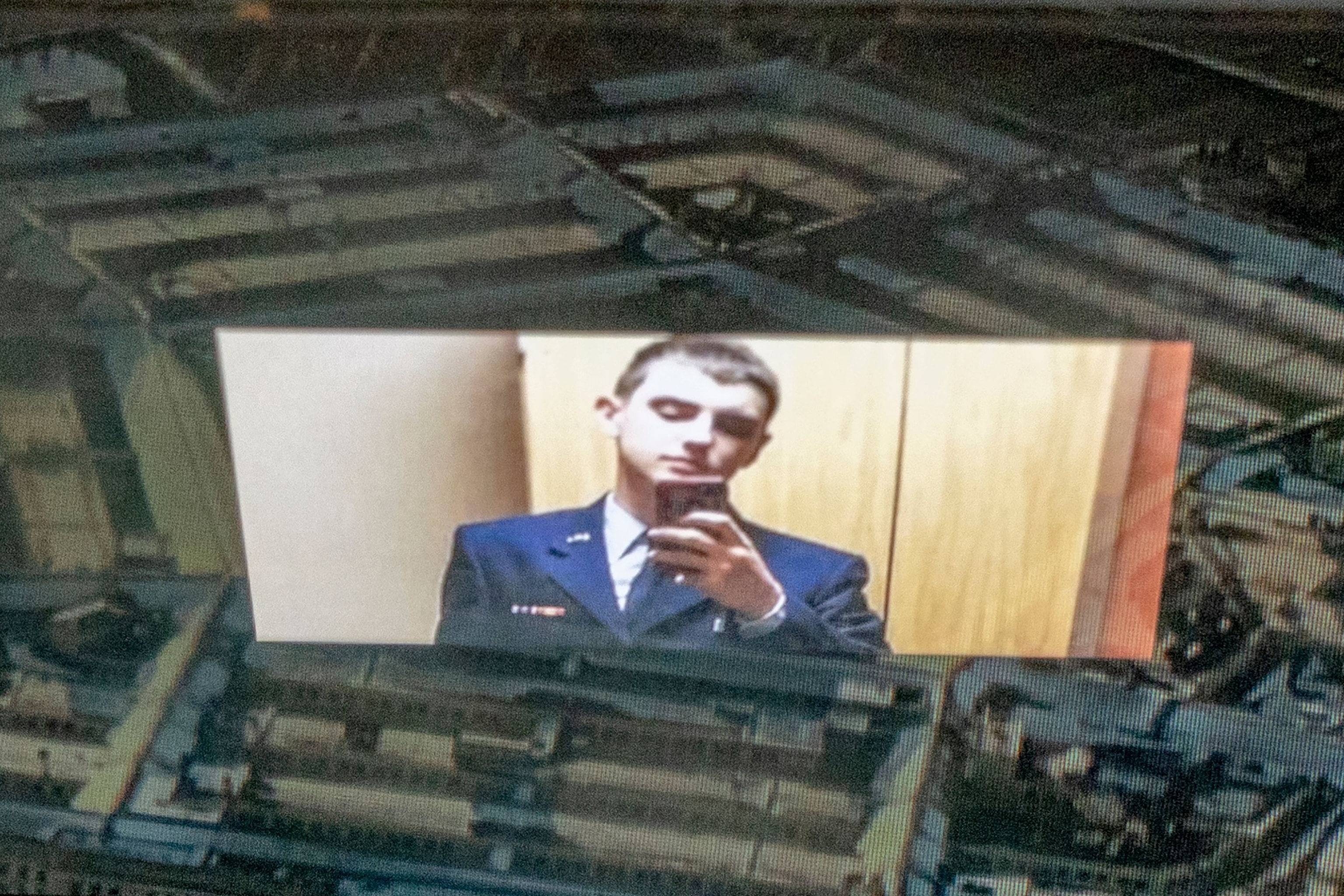 This photo illustration shows the suspect, national guardsman Jack Teixeira, reflected in an image of the Pentagon in Washington, DC. 