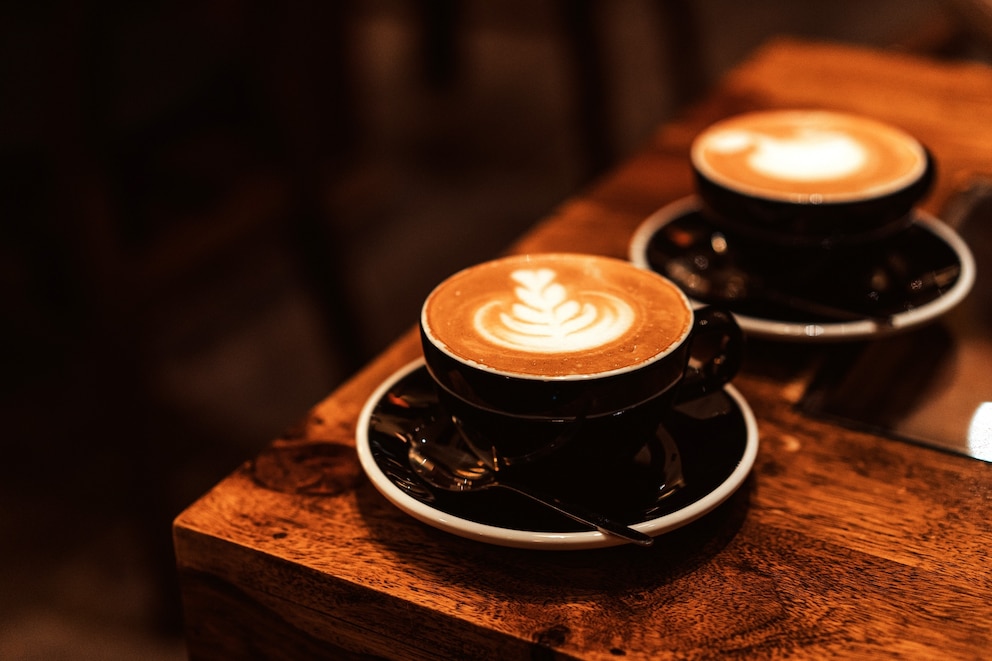 PHOTO: Two coffee cups with latte art on the wooden table