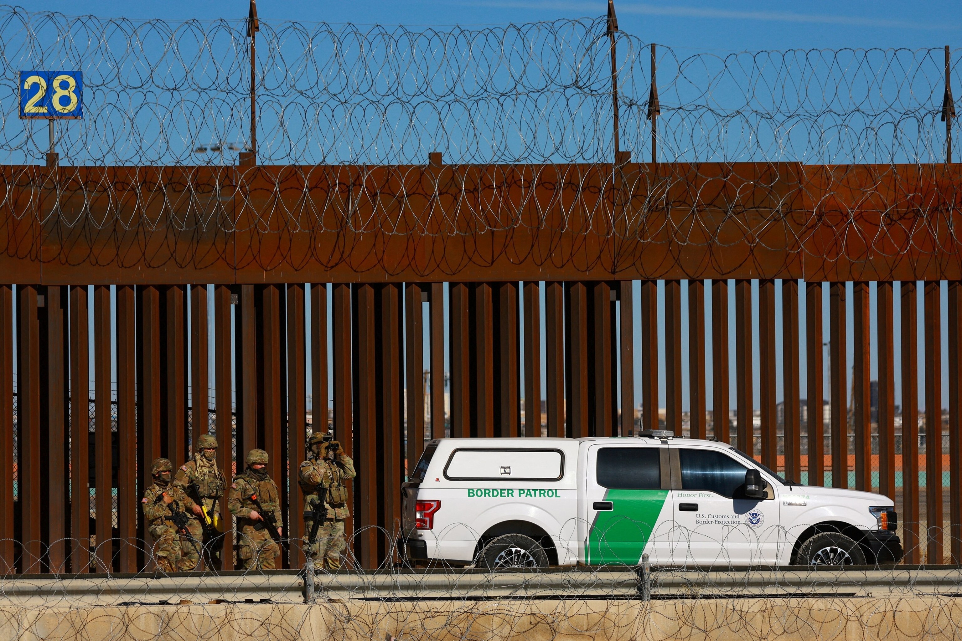PHOTO: Members of the Texas National Guard stand guard near the border wall between Mexico and the United States, as seen from Ciudad Juarez, Mexico, Jan.  14, 2025. 