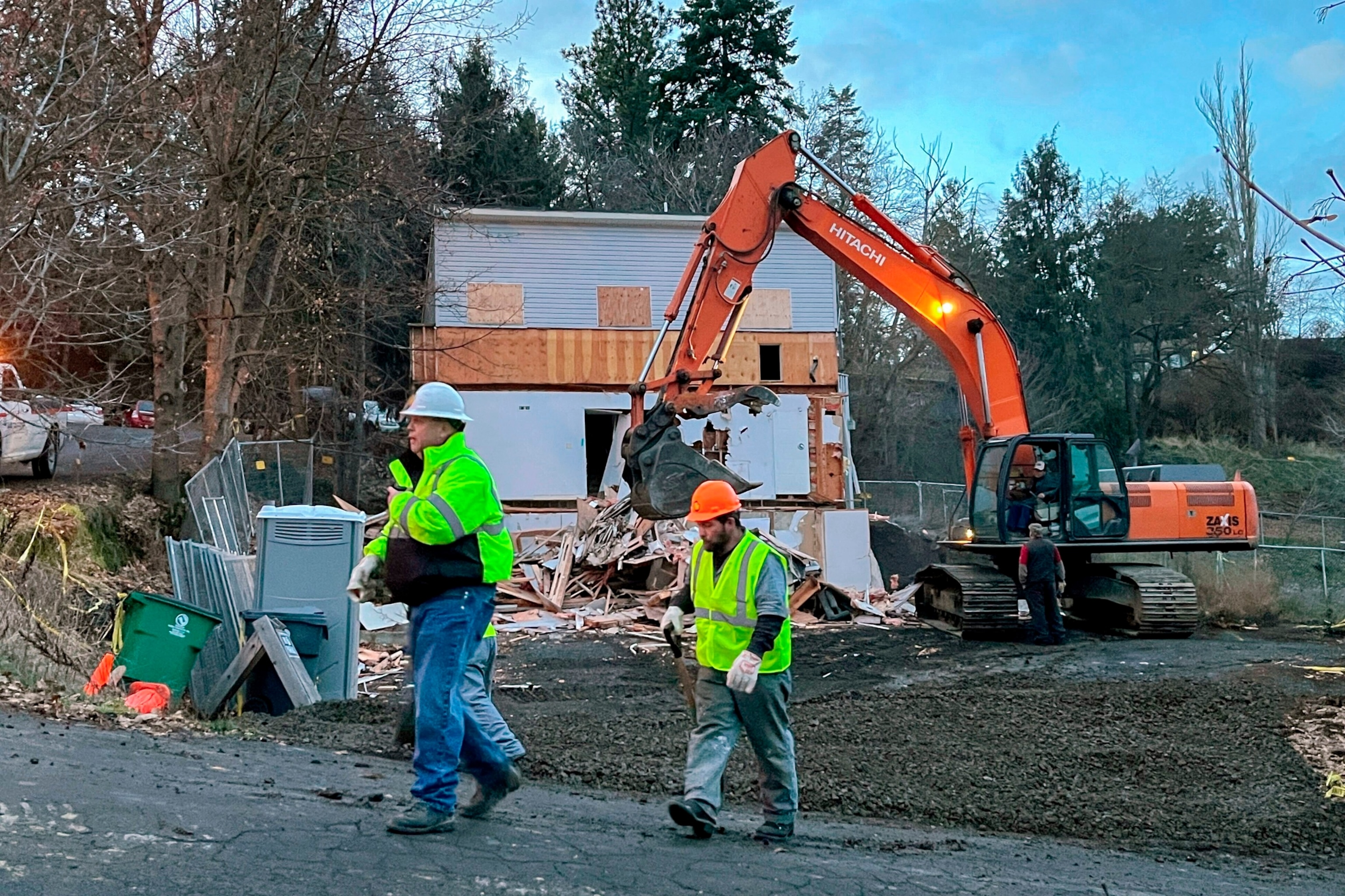 PHOTO: In this Dec. 28, 2023, file photo, workers walk past the demolition of a home in Moscow, Idaho, where four University of Idaho students were killed last year.