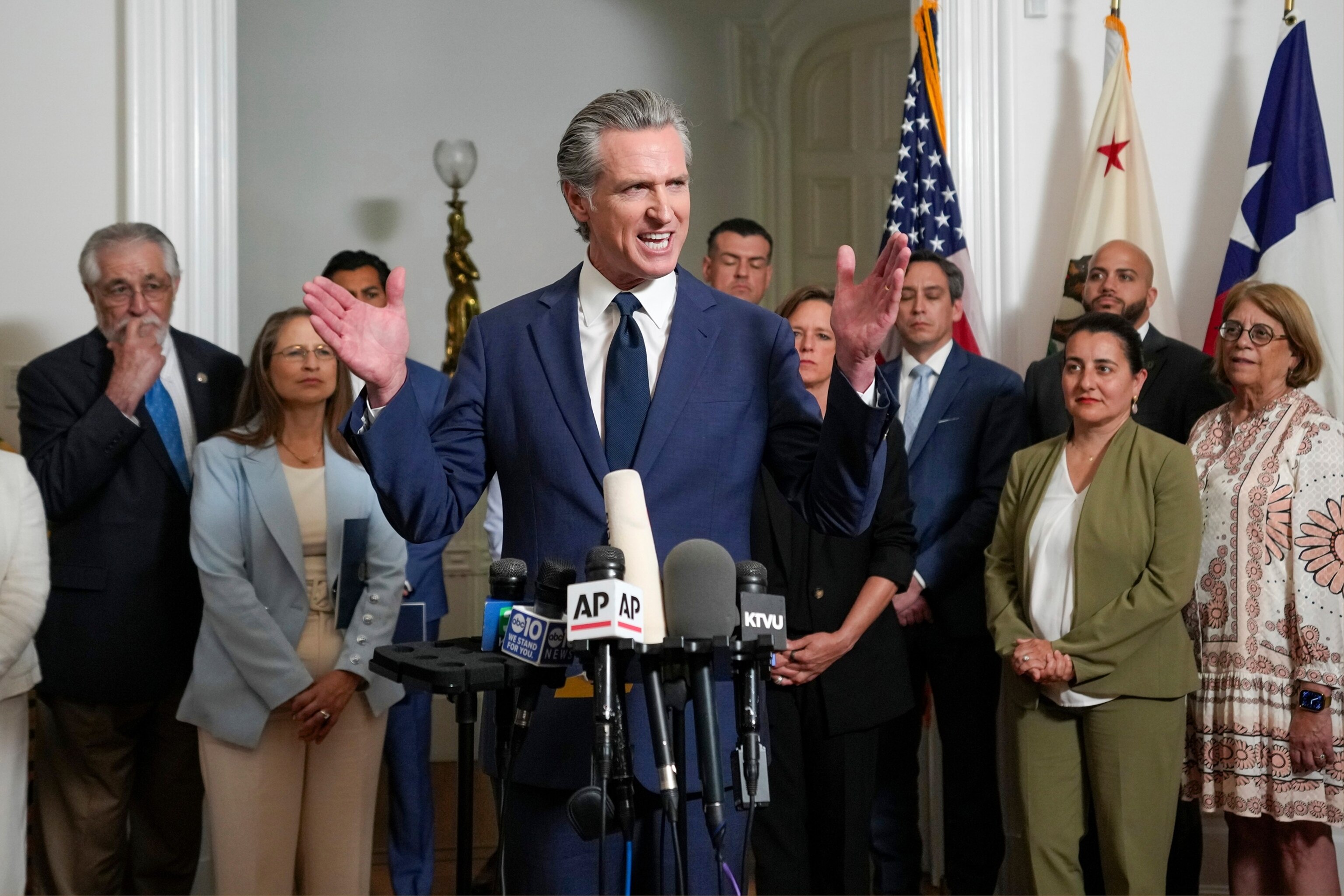 PHOTO: California Gov. Gavin Newsom, center, discusses the push to schedule a special election to redraw California's Congressional voting districts, during a news conference in Sacramento, Calif., Aug. 8, 2025.