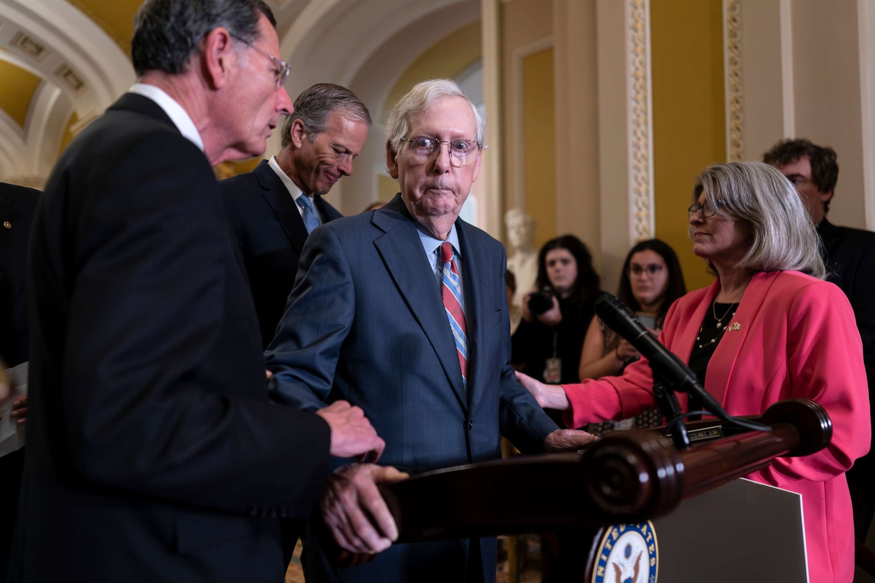 PHOTO: Senate Minority Leader Mitch McConnell is helped by, Sen. John Barrasso after the GOP leader froze at the microphones as he arrived for a news conference, at the Capitol in Washington, July 26, 2023.