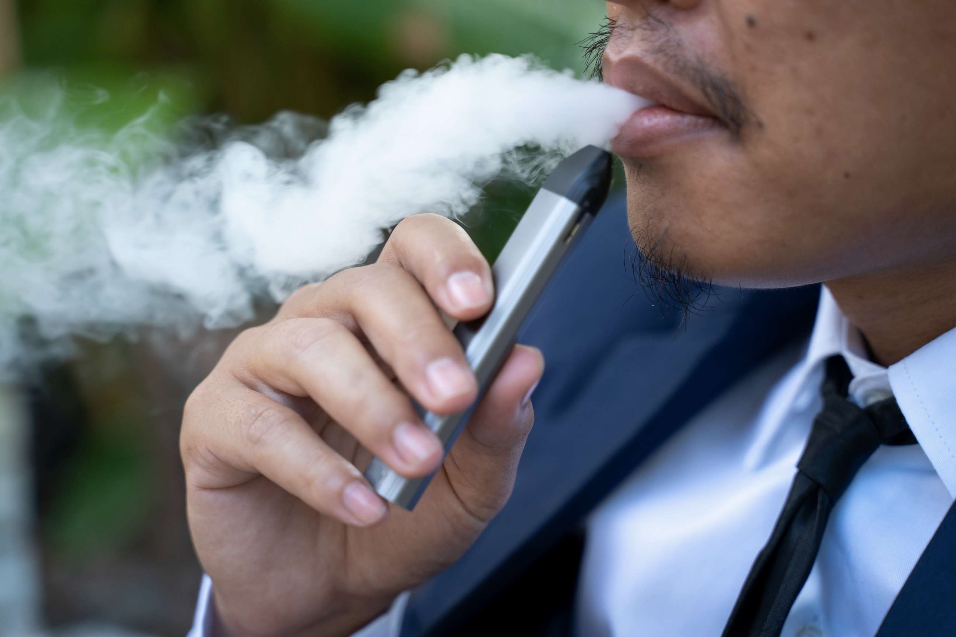 PHOTO: Young male worker smoking electronic cigarette (Stock photo)