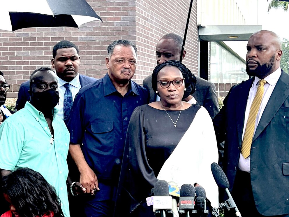 PHOTO: Wanda Cooper-Jones and Marcus Arbery, parents of Ahmaud Arbery, are flanked by Rev. Jesse Jackson and Attorney Lee Merritt while addressing the media following the sentencing of Travis McMichael in federal court in Brunswick, Ga. on Aug. 8, 2022.