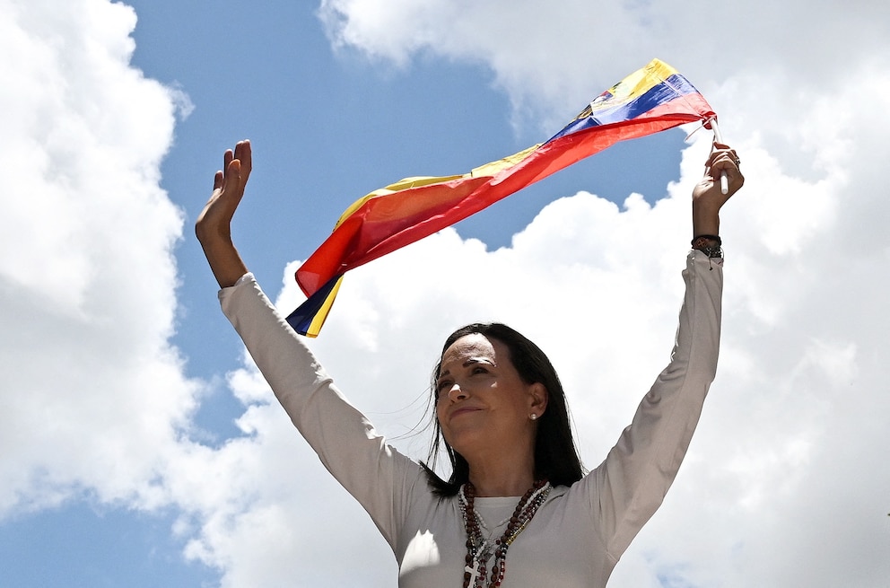 PHOTO: Venezuelan opposition leader Maria Corina Machado waves a Venezuelan flag during a rally in Caracas on August 28, 2024.