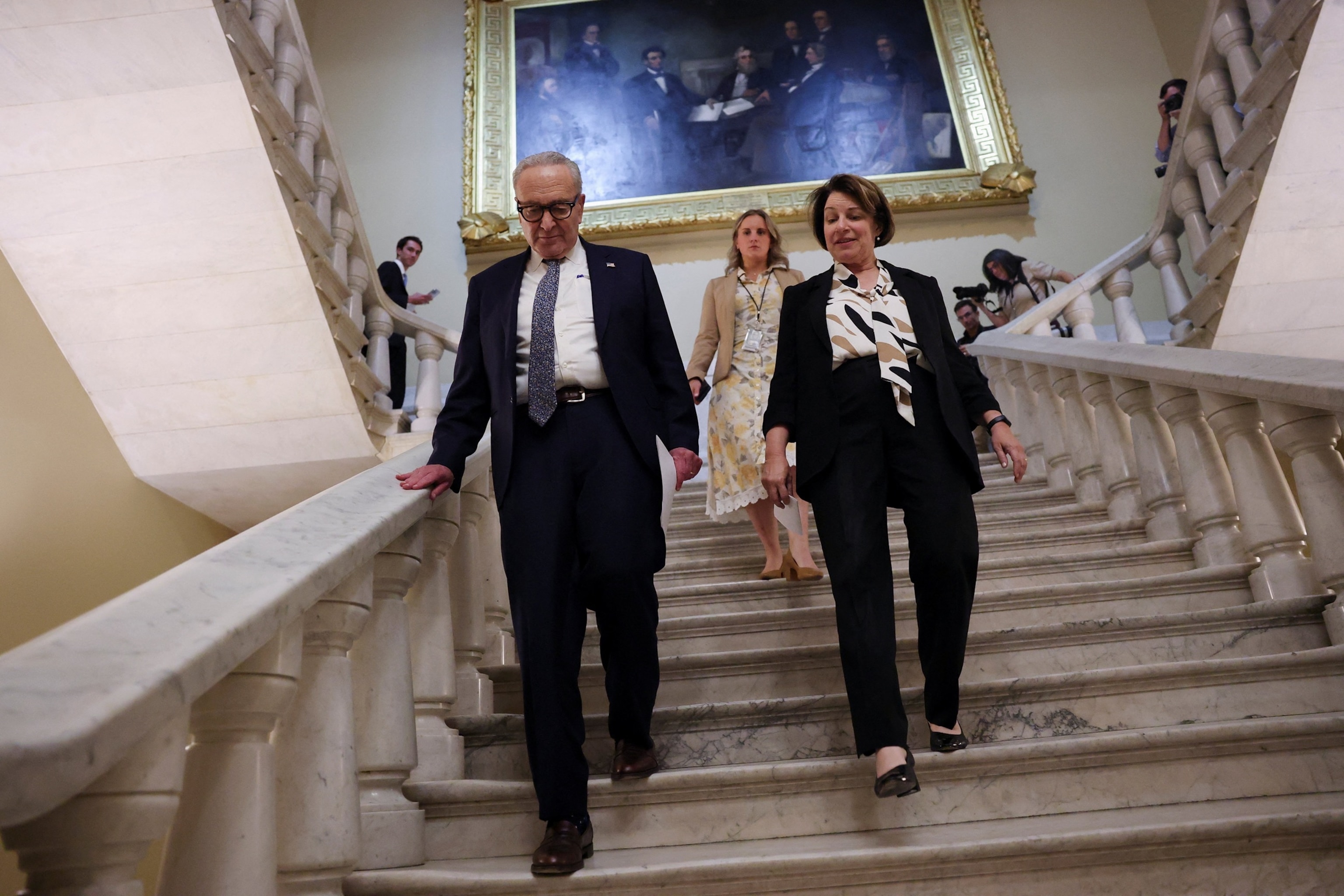 PHOTO: U.S. Senate Minority Leader Chuck Schumer (D-NY) and U.S. Senator Amy Klobuchar (D-MN) leave after a press conference on Capitol Hill in Washington, Sept. 30, 2025. 