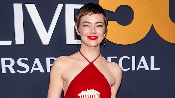 emma stone red dress popcorn Emma Stone Stuffs Her Dress Pockets With Popcorn for 'SNL50'