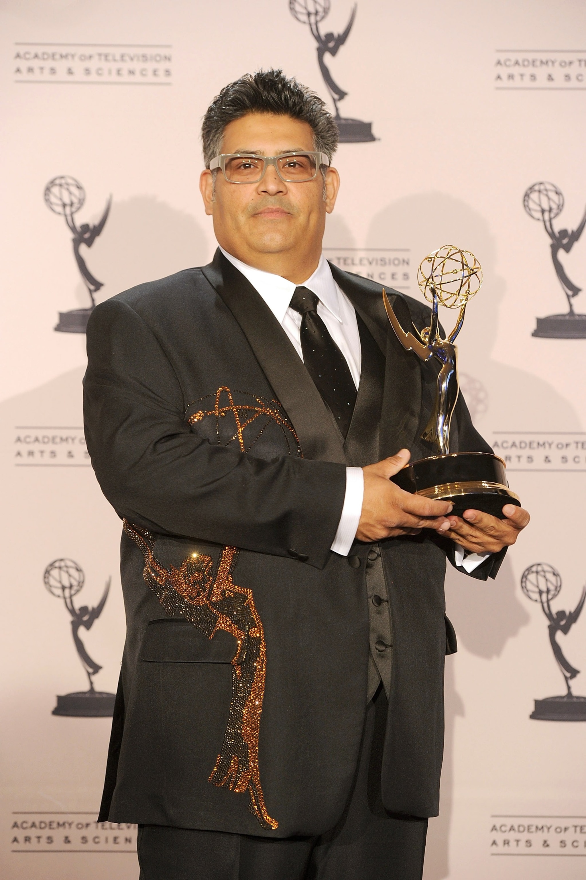 PHOTO: Costume designer Rodney Munoz poses with an Emmy Award for Outstanding Costumes for a Variety/Music Program or a Special (juried award) for "Jimmy Kimmel Live" in press room during the 62nd Primetime Creative Arts Emmy Awards in Los Angeles.