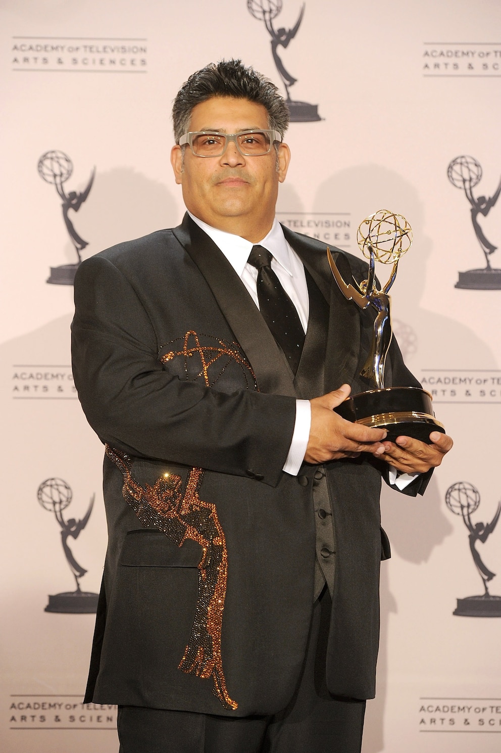 PHOTO: Costume designer Rodney Munoz poses with an Emmy Award for Outstanding Costumes for a Variety/Music Program or a Special (juried award) for "Jimmy Kimmel Live" in press room during the 62nd Primetime Creative Arts Emmy Awards in Los Angeles.