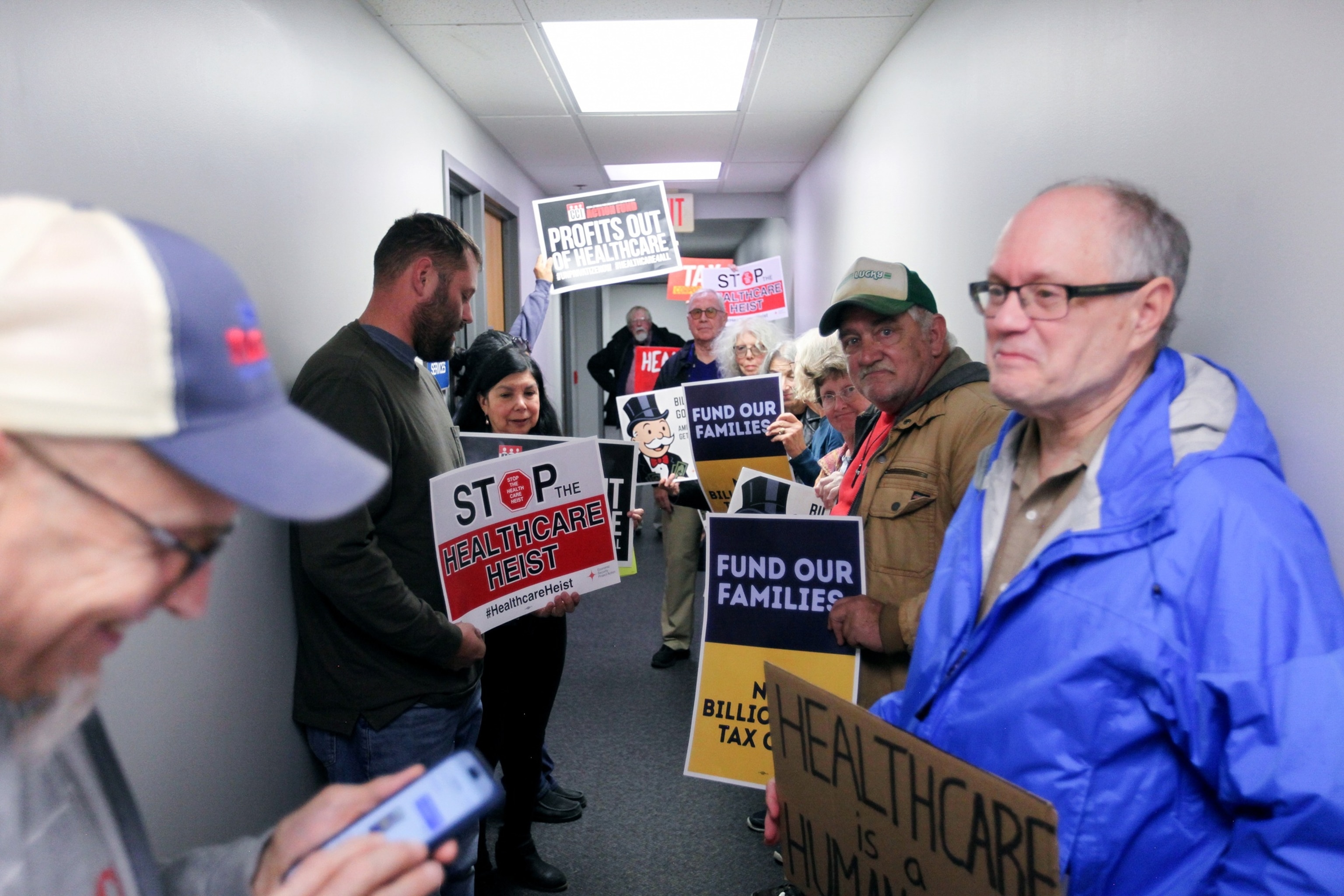 PHOTO: Protestors wait outside the offices of Sen. Joni Ernst and Rep. Mariannette Miller-Meeks to voice their healthcare concerns on November 5, 2025, in Davenport, Iowa.