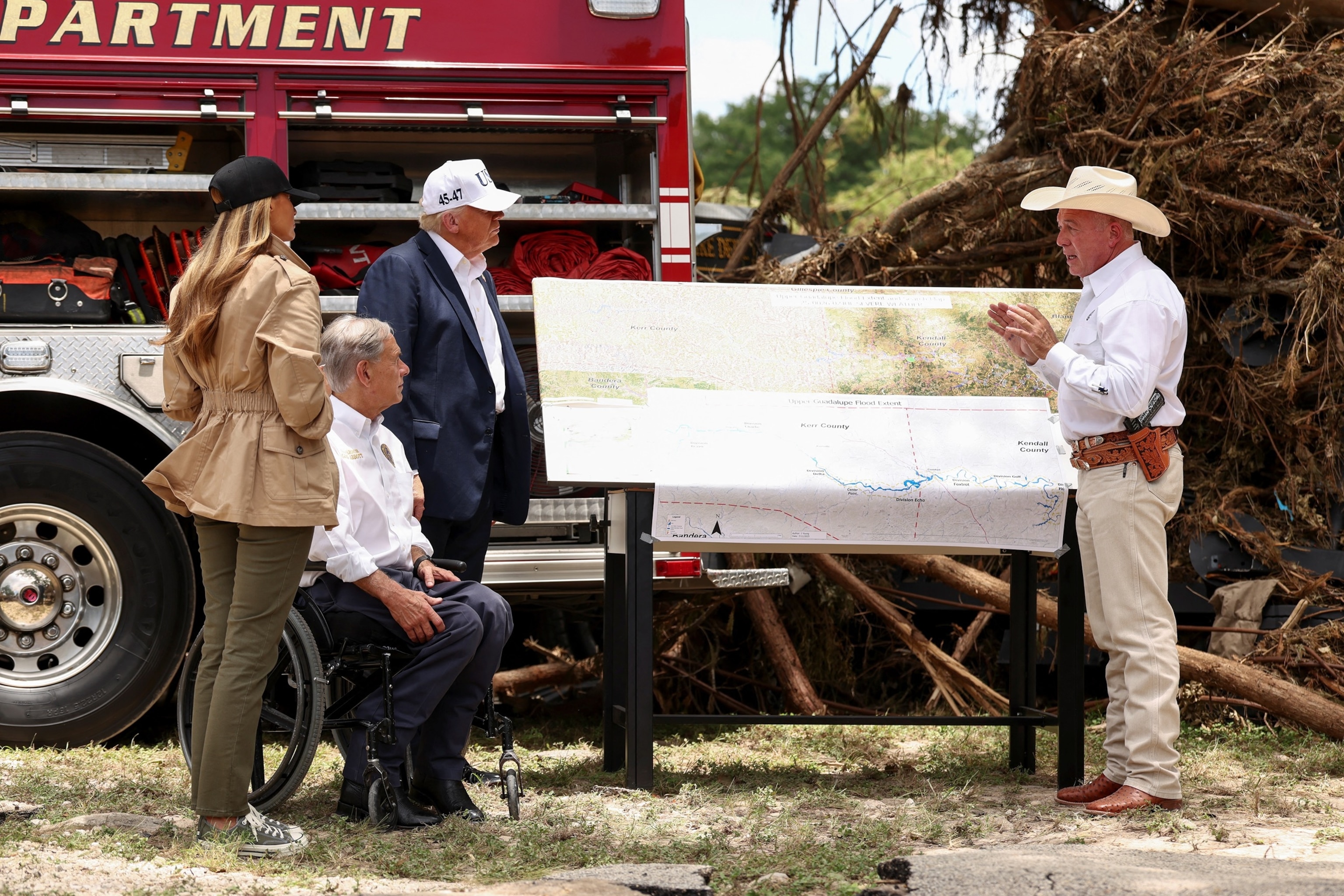 PHOTO: President Donald Trump, first lady Melania Trump and Texas Governor Greg Abbott receive a briefing in Kerr County, Texas, U.S., July 11, 2025.