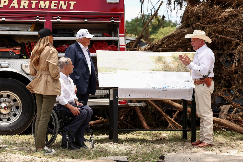 PHOTO: President Donald Trump, first lady Melania Trump and Texas Governor Greg Abbott receive a briefing in Kerr County, Texas, U.S., July 11, 2025.