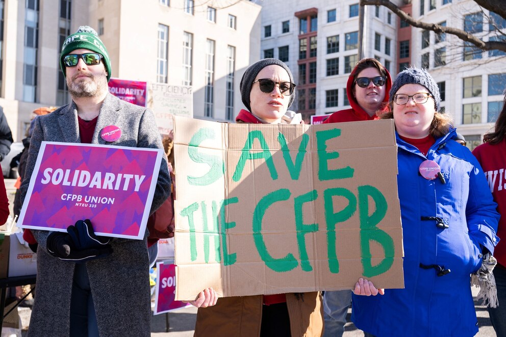 PHOTO: Demonstrators protest against cuts to the Consumer Financial Protection Bureau by President Donald Trump and Elon Musks's DOGE initiative, as a hearing is scheduled to take place in Washington, D.C., on March 3, 2025.