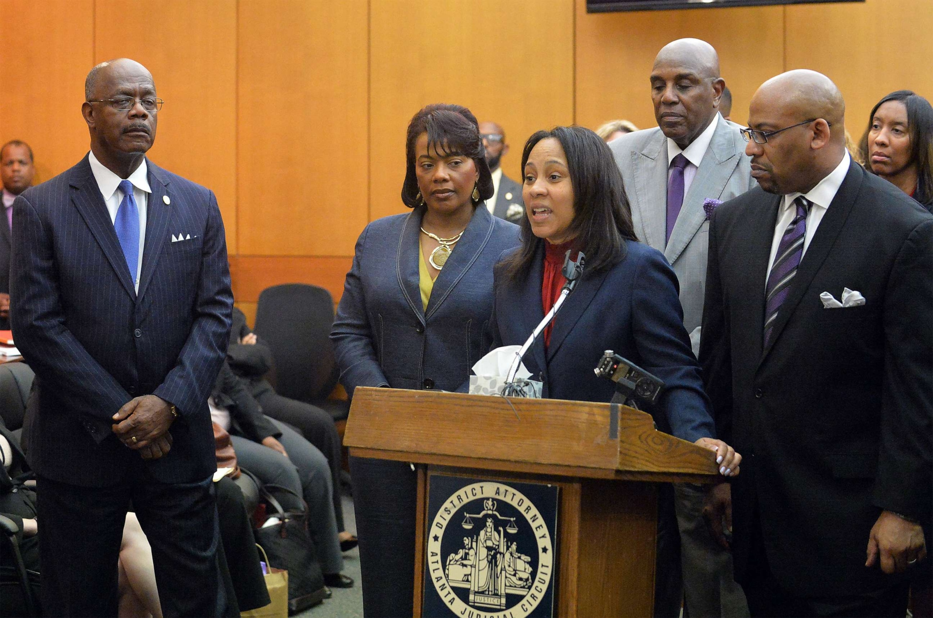 PHOTO: District Attorney Paul Howard, left, stands by the podium while prosecutor Fani Willis, center, speaks during a news conference following sentencing for 10 defendants convicted in the Atlanta Public Schools test-cheating trial, April 14, 2015.