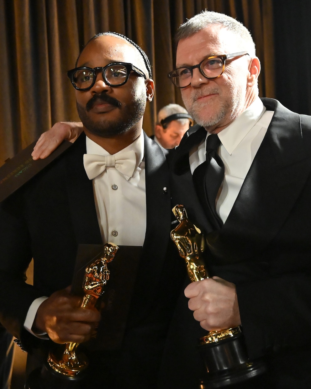 PHOTO: Ryan Coogler, winner of the Original Screenplay award poses with Paul Thomas Anderson, winner of the Writing (Adapted Screenplay) award for "One Battle After Another" backstage at the 98th Academy Awards, March 15, 2026 in Hollywood, Calif.