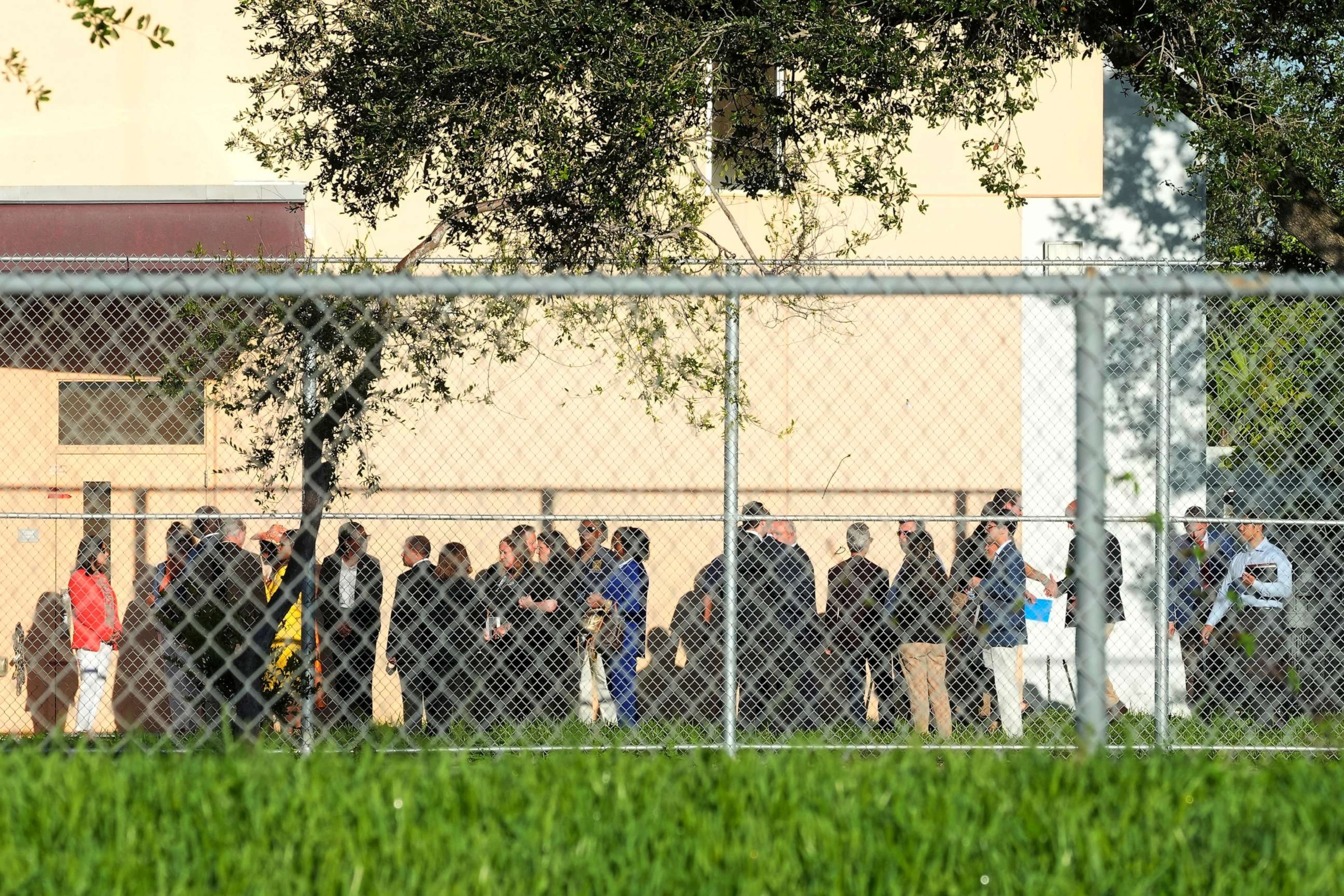 PHOTO: Nine members of Congress and others wait to enter Marjory Stoneman Douglas High School, Friday, Aug. 4, 2023, in Parkland, Fla.