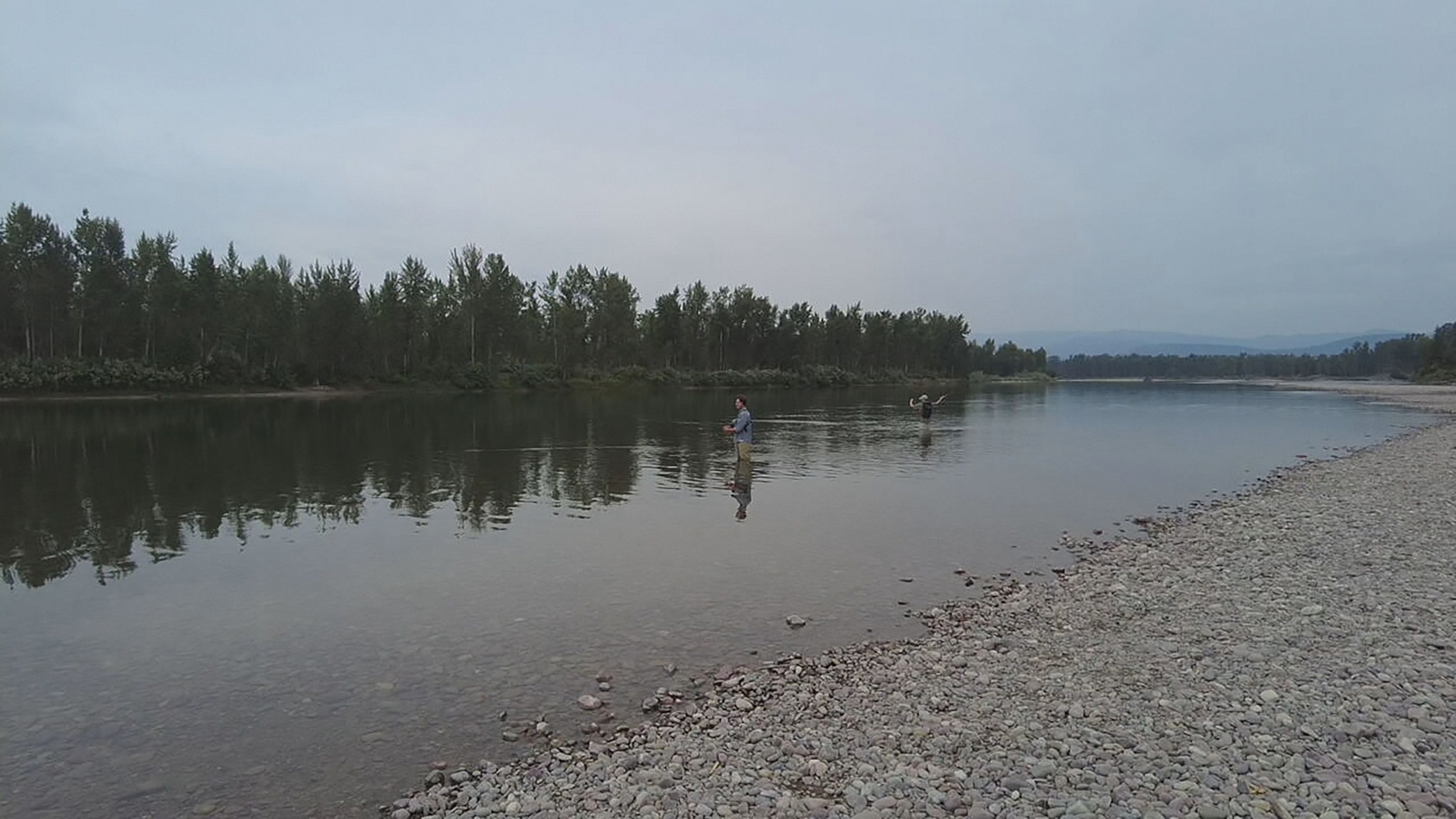 PHOTO: Lander and Badge Busse fish for rainbow and cutthroat trout on the Flathead River in Kalispell, Montana.