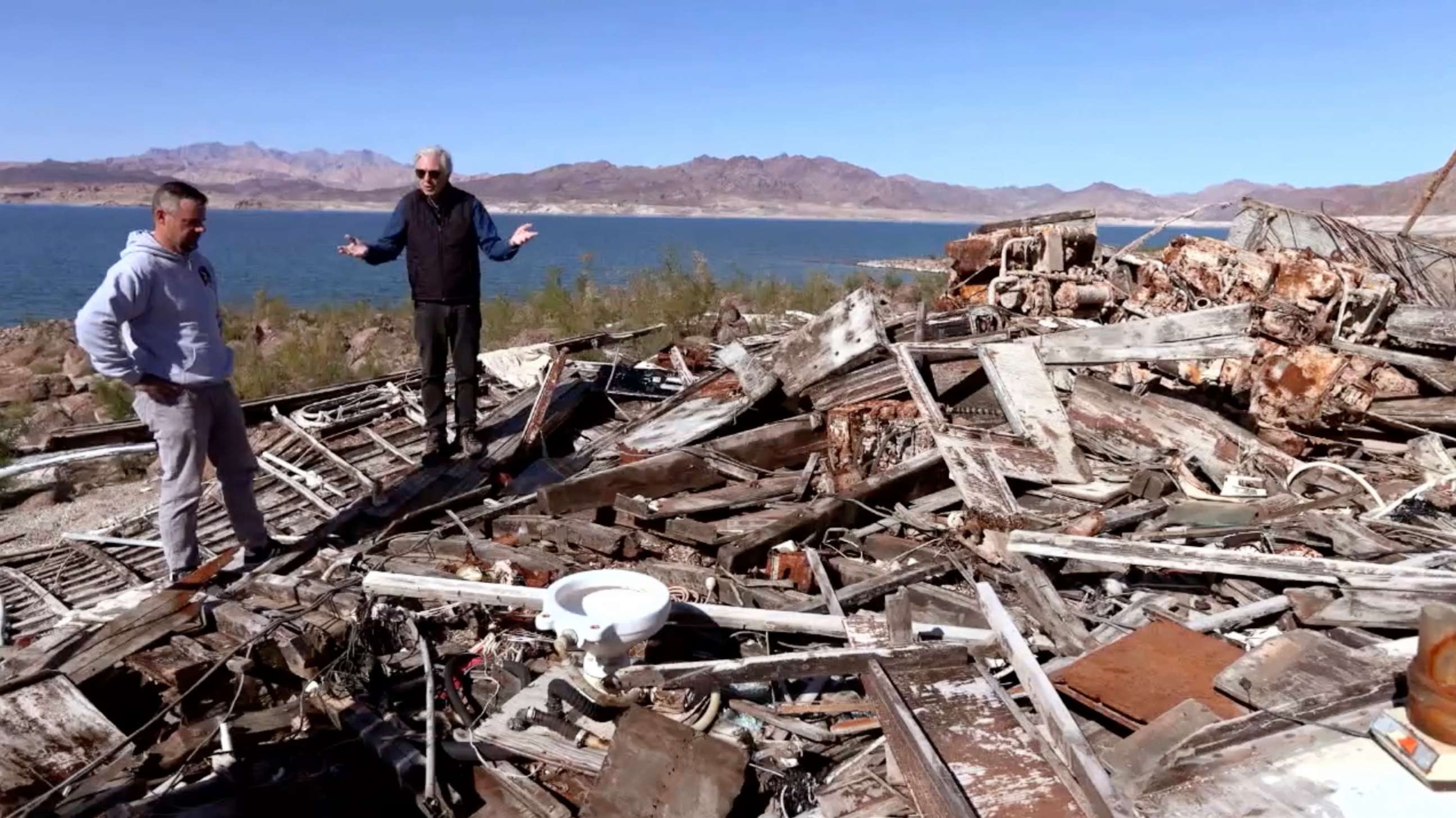 PHOTO: ABC News' Chris Connelly surveys a previously submerged boat wreck on Lake Mead.