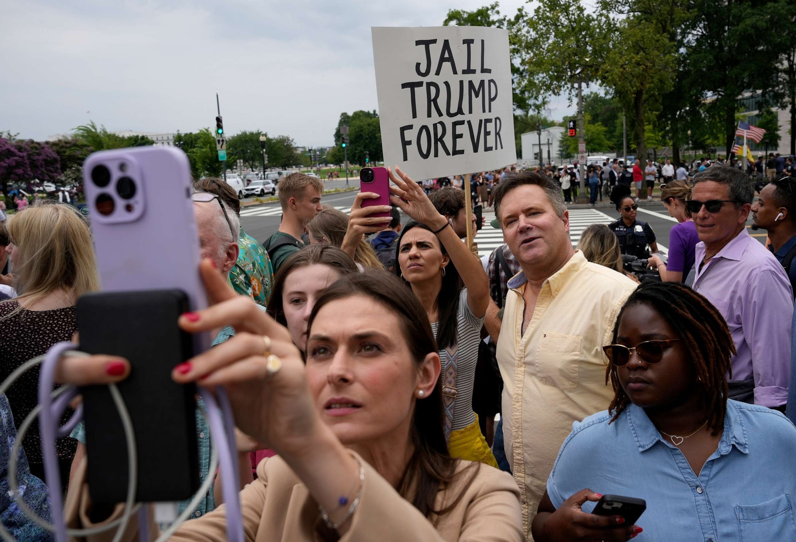 PHOTO: People try to catch a glimpse of the motorcade of former U.S. President Donald Trump as he arrives at the E. Barrett Prettyman U.S. Court House on Aug. 3, 2023 in Washington, D.C.