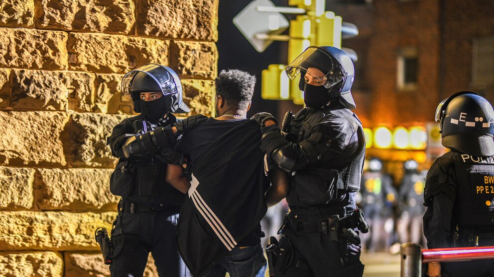 A man is taken away by police officers in Stuttgart, Baden-Württemberg, Germany, on Saturday, Sept. 16, 2023, after clashes at a gathering of Eritrean groups. (Jason Tschepljakow/dpa via AP)