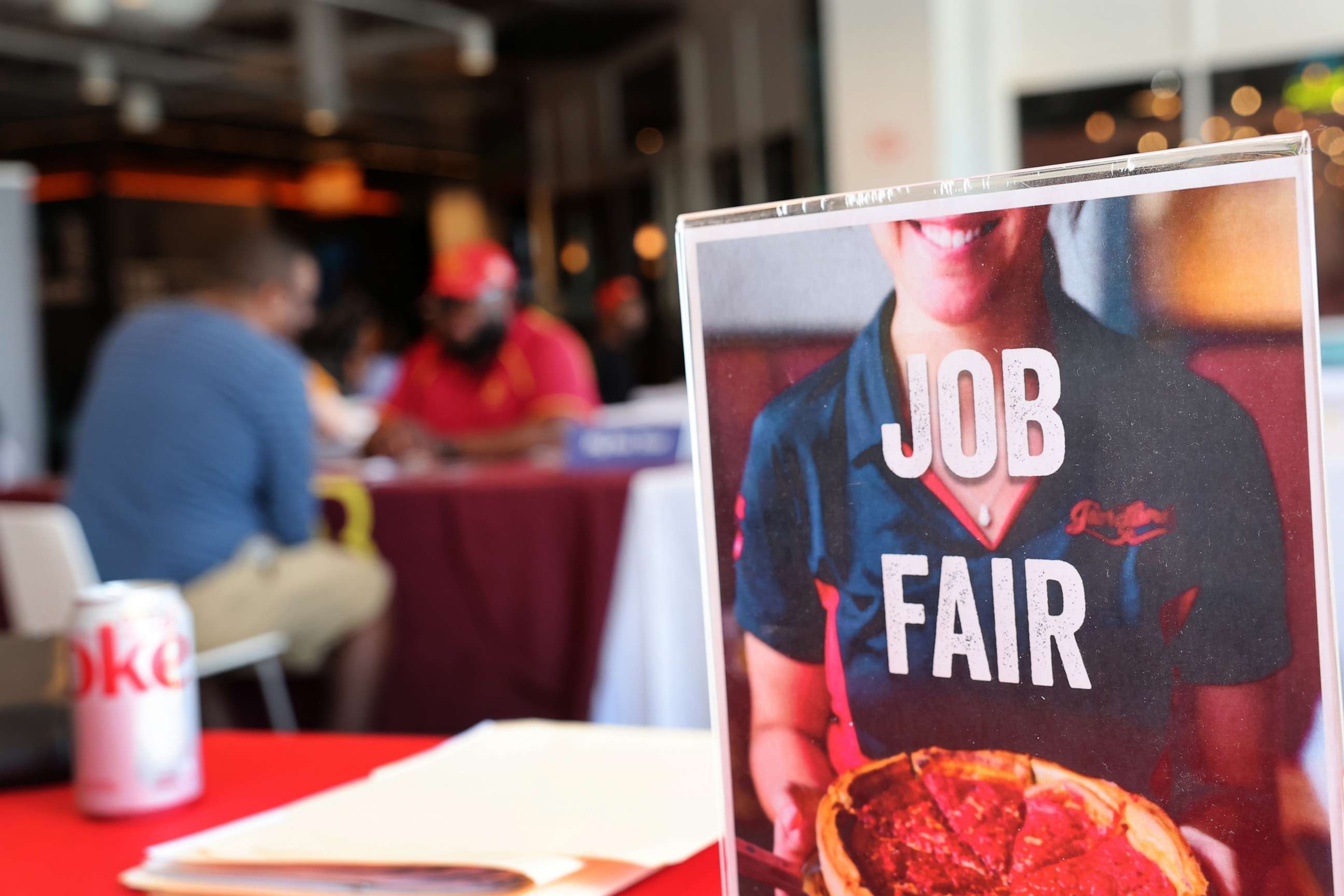 PHOTO: Job seekers speak with recruiters during a job fair at Navy Pier, April 11, 2023, in Chicago.