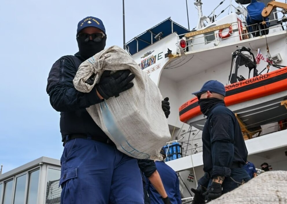 PHOTO: A Coast Guard Cutter Diligence (WMEC 616) crew member carries a bundle of illicit narcotics off the cutter during a drug offload at Coast Guard Sector St. Petersburg, Florida, Sept. 22, 2025.